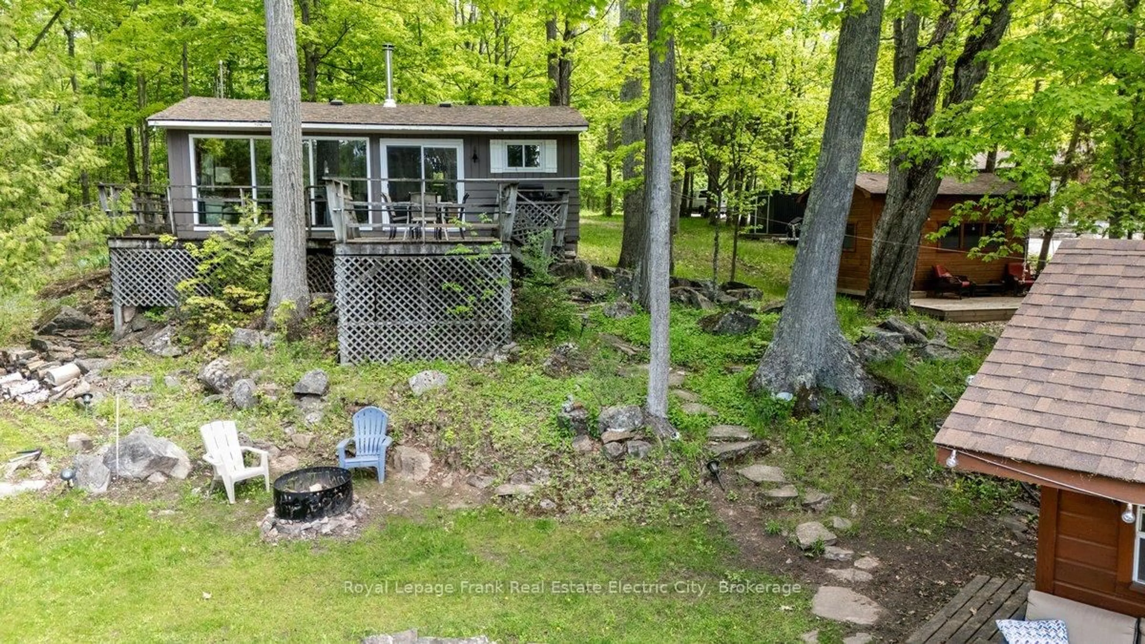 A pic from outside/outdoor area/front of a property/back of a property/a pic from drone, forest/trees view for 28 Fire Route 96, Trent Lakes Ontario K0M 1A0