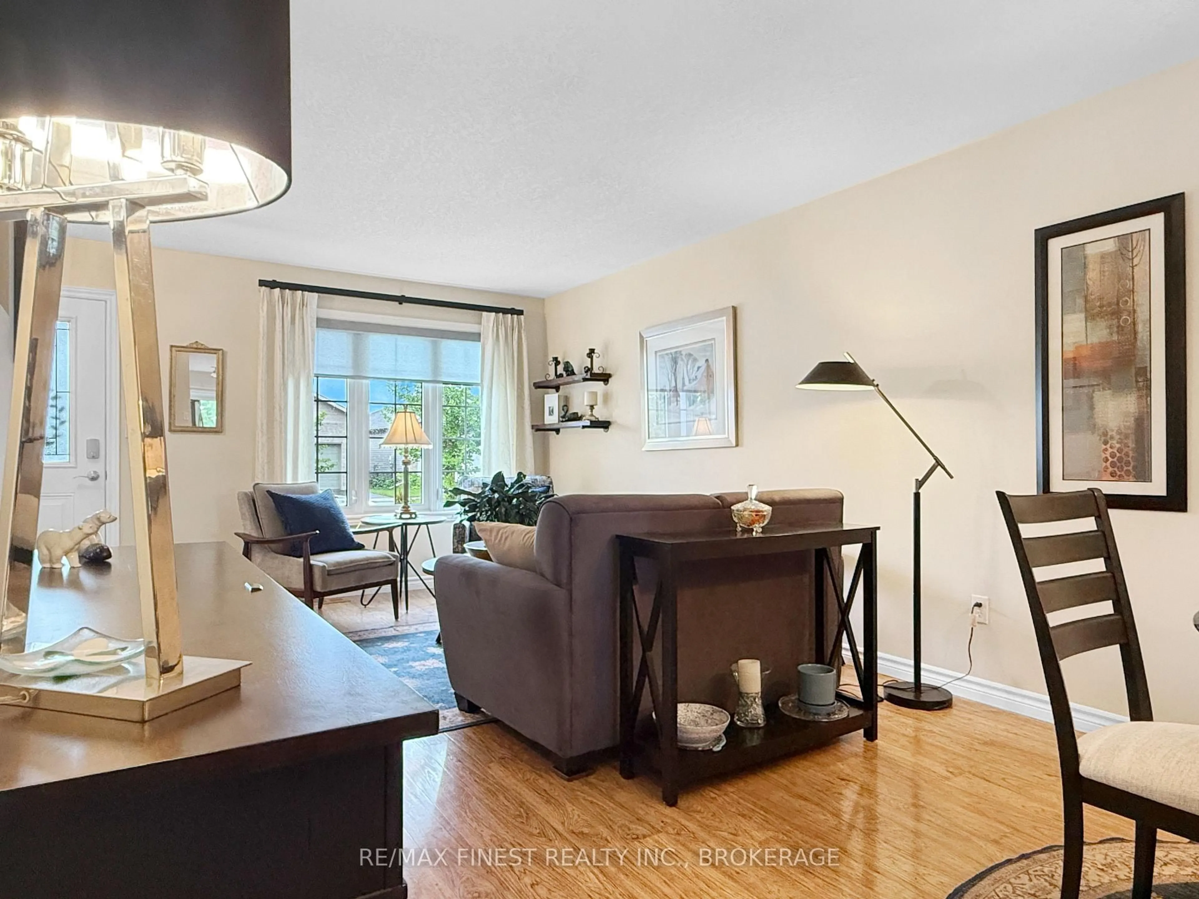Living room with furniture, wood/laminate floor for 119 Hogan Cres, Loyalist Ontario K7N 0A6