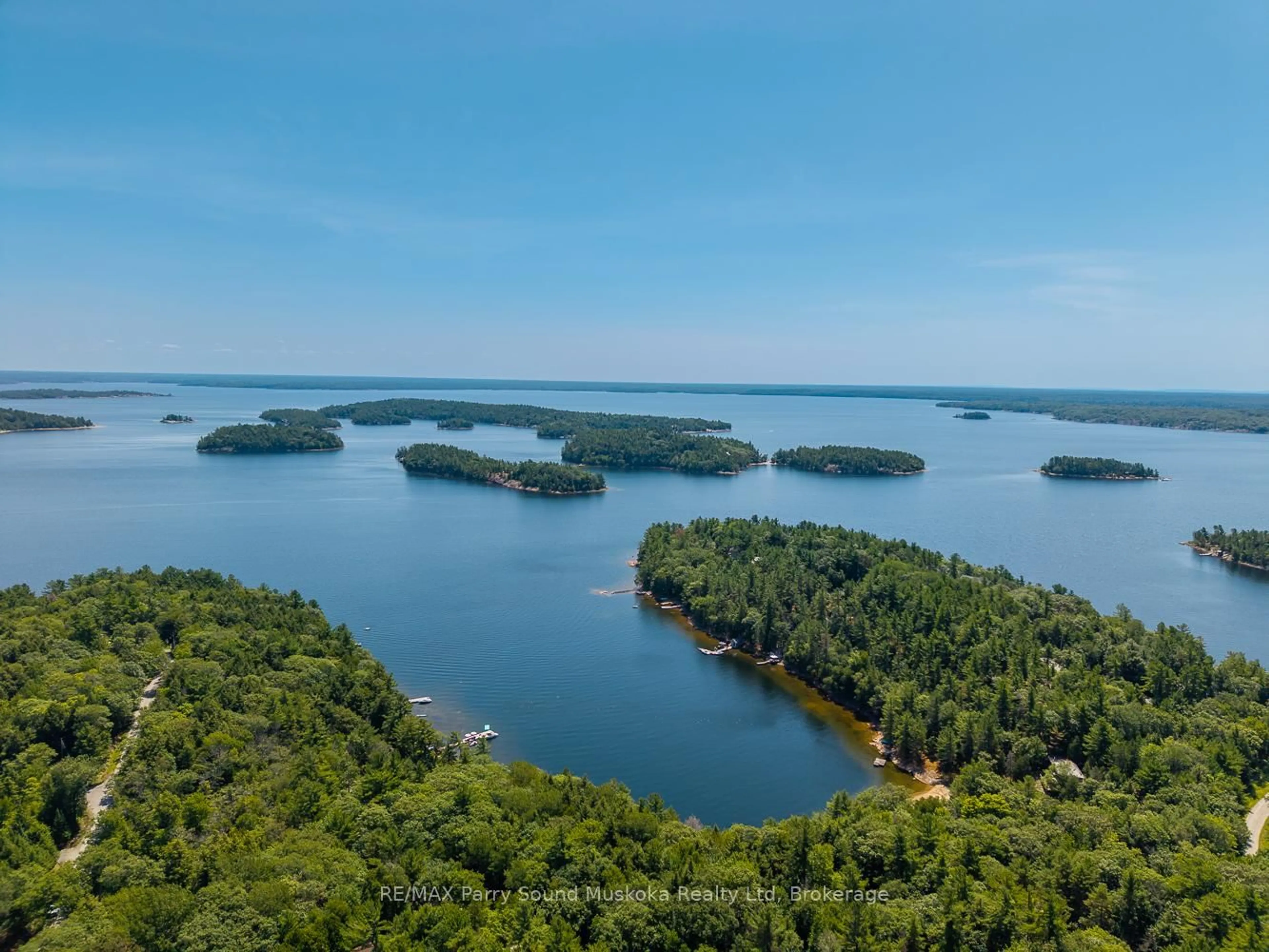 A pic from outside/outdoor area/front of a property/back of a property/a pic from drone, water/lake/river/ocean view for 113 Bayview Dr, Carling Ontario P0G 1G0
