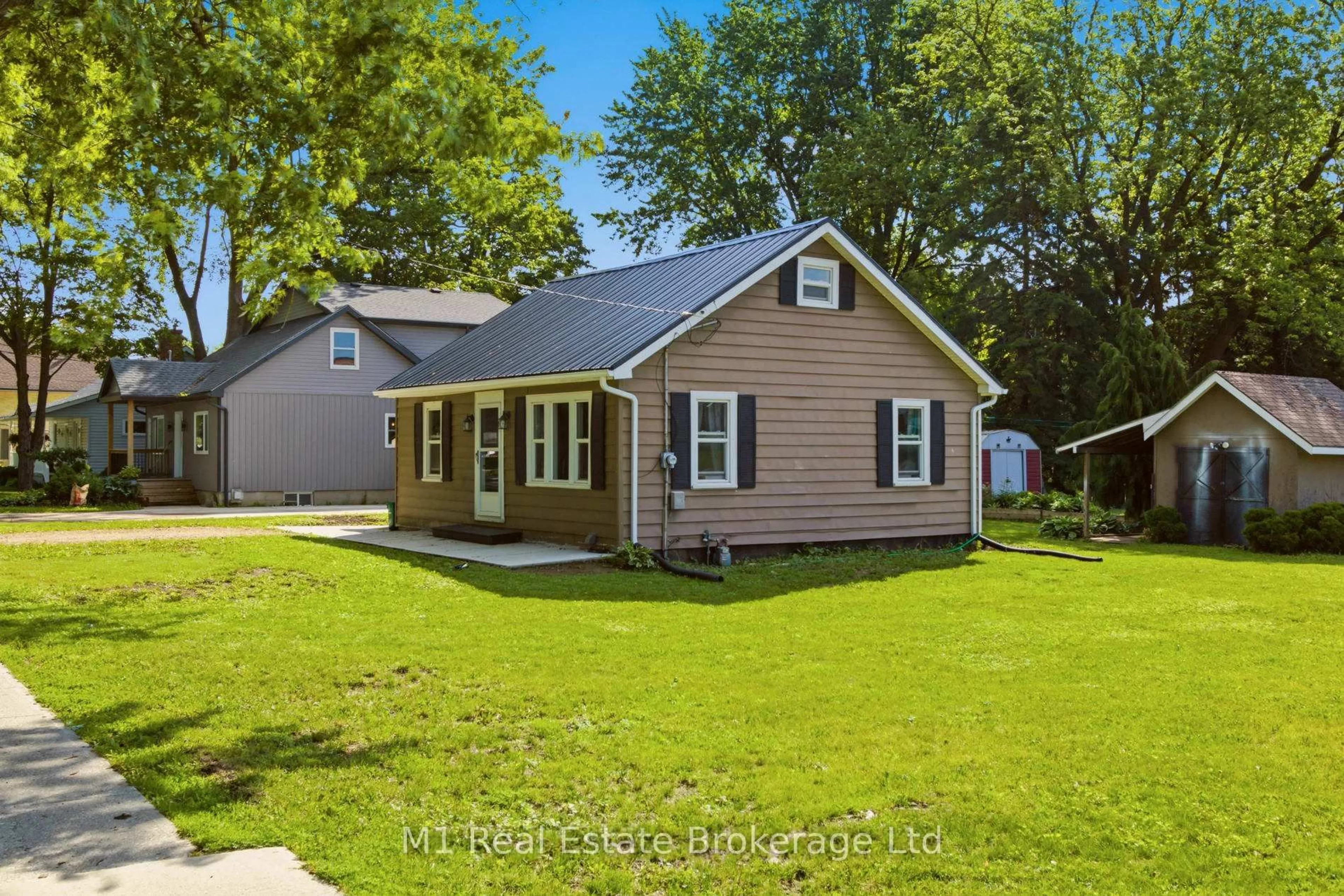 Home with vinyl exterior material, street for 204 King St, Wellington North Ontario N0G 2L2