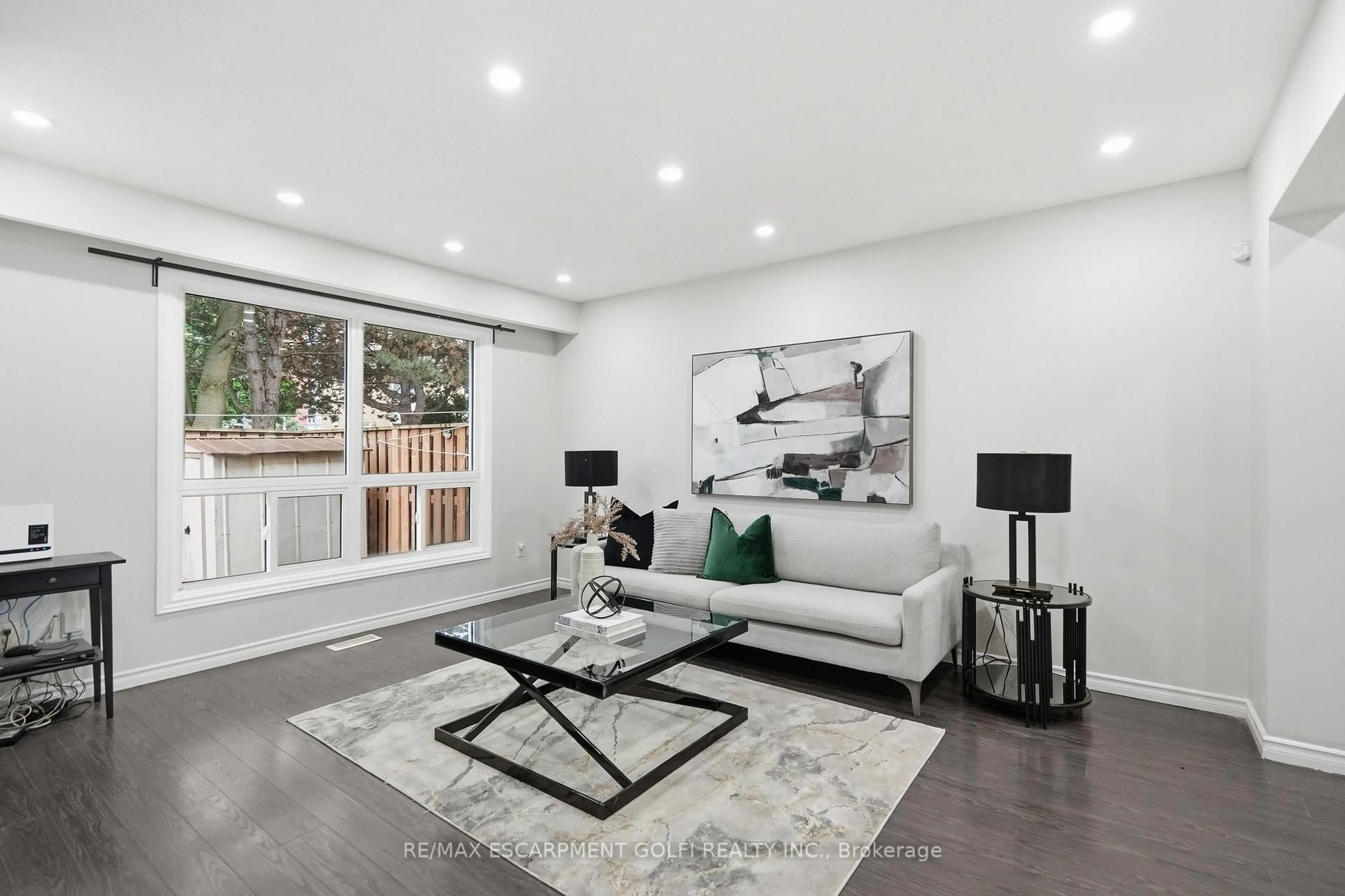 Living room with furniture, wood/laminate floor for 82 Riverdale Dr #14, Hamilton Ontario L8E 1K3