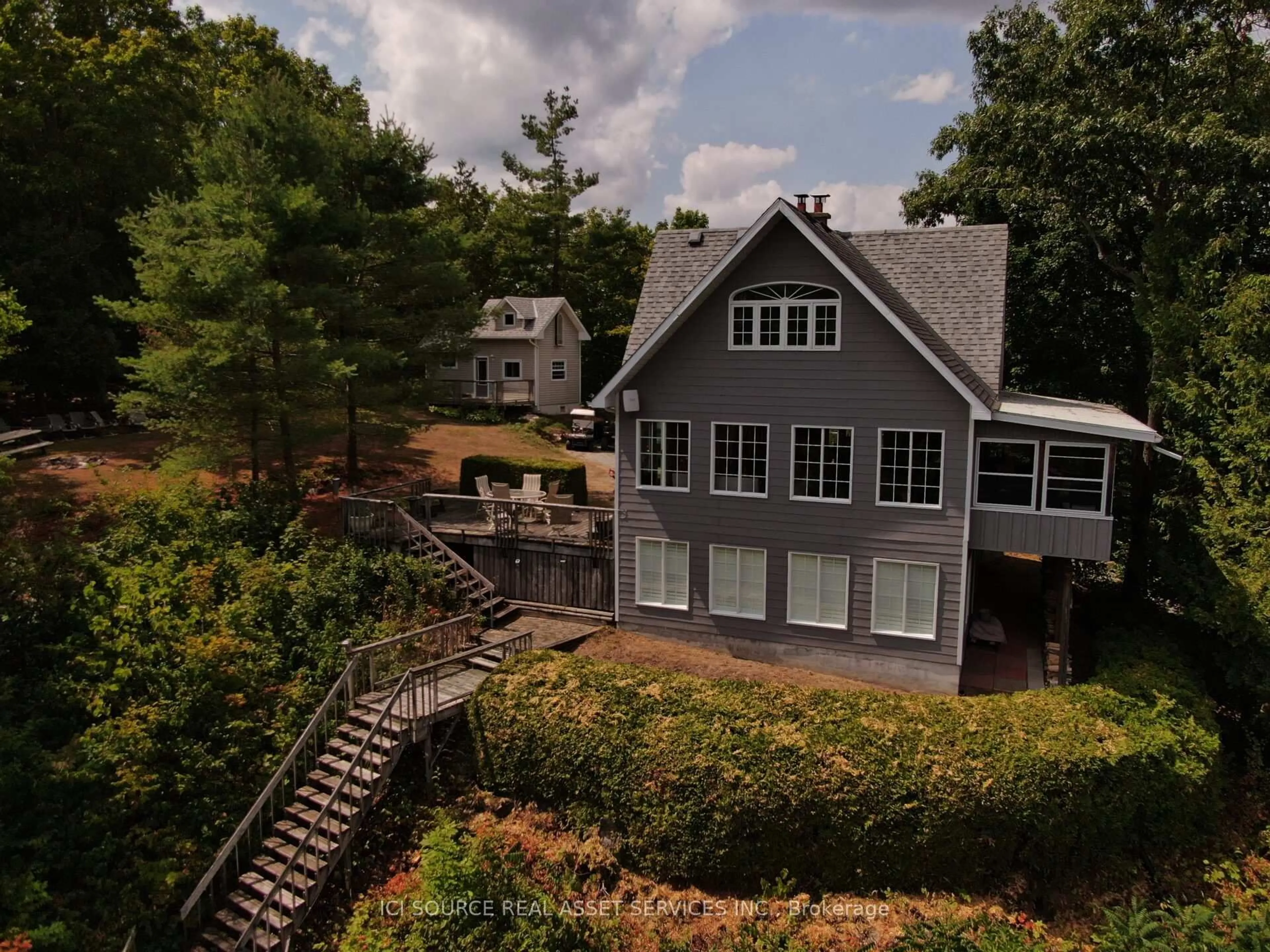 A pic from outside/outdoor area/front of a property/back of a property/a pic from drone, water/lake/river/ocean view for 1096 Lois Lane, Minden Hills Ontario K0M 2L1