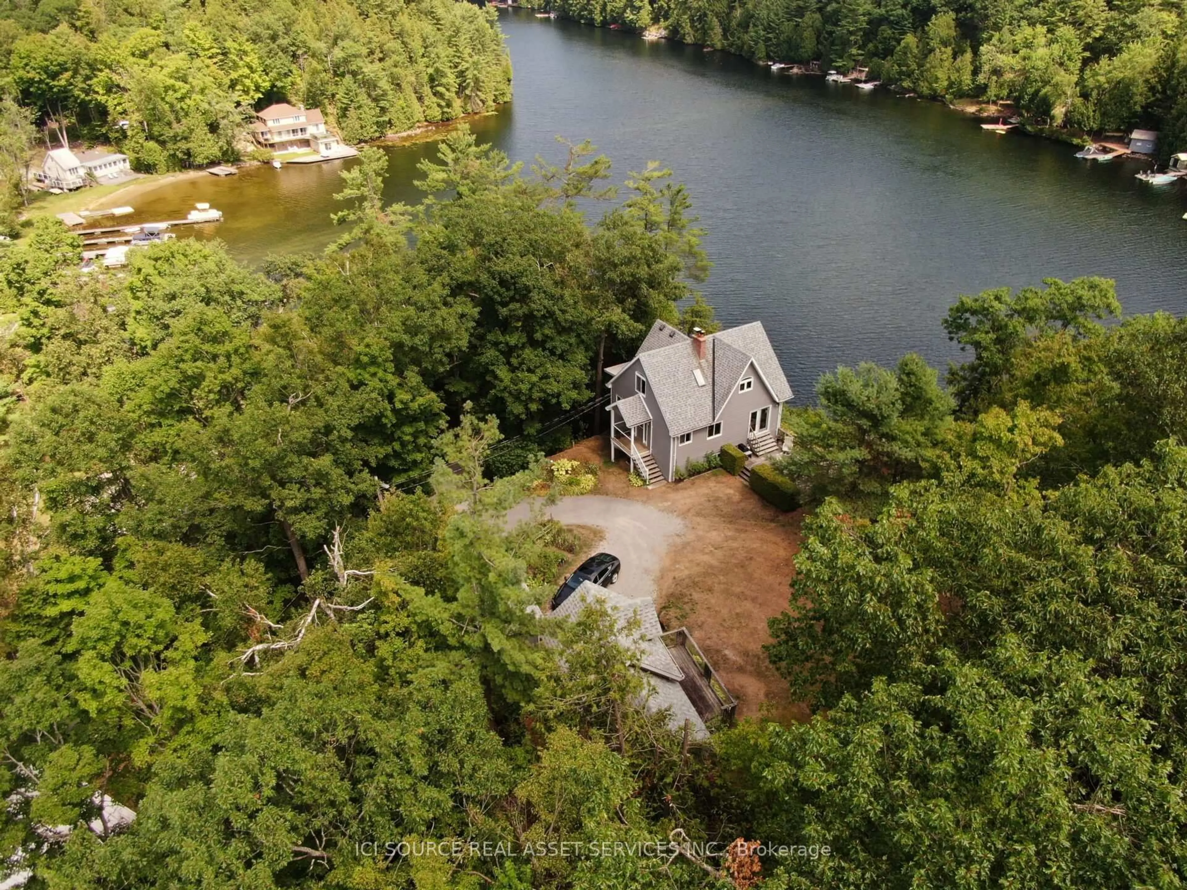 A pic from outside/outdoor area/front of a property/back of a property/a pic from drone, water/lake/river/ocean view for 1096 Lois Lane, Minden Hills Ontario K0M 2L1
