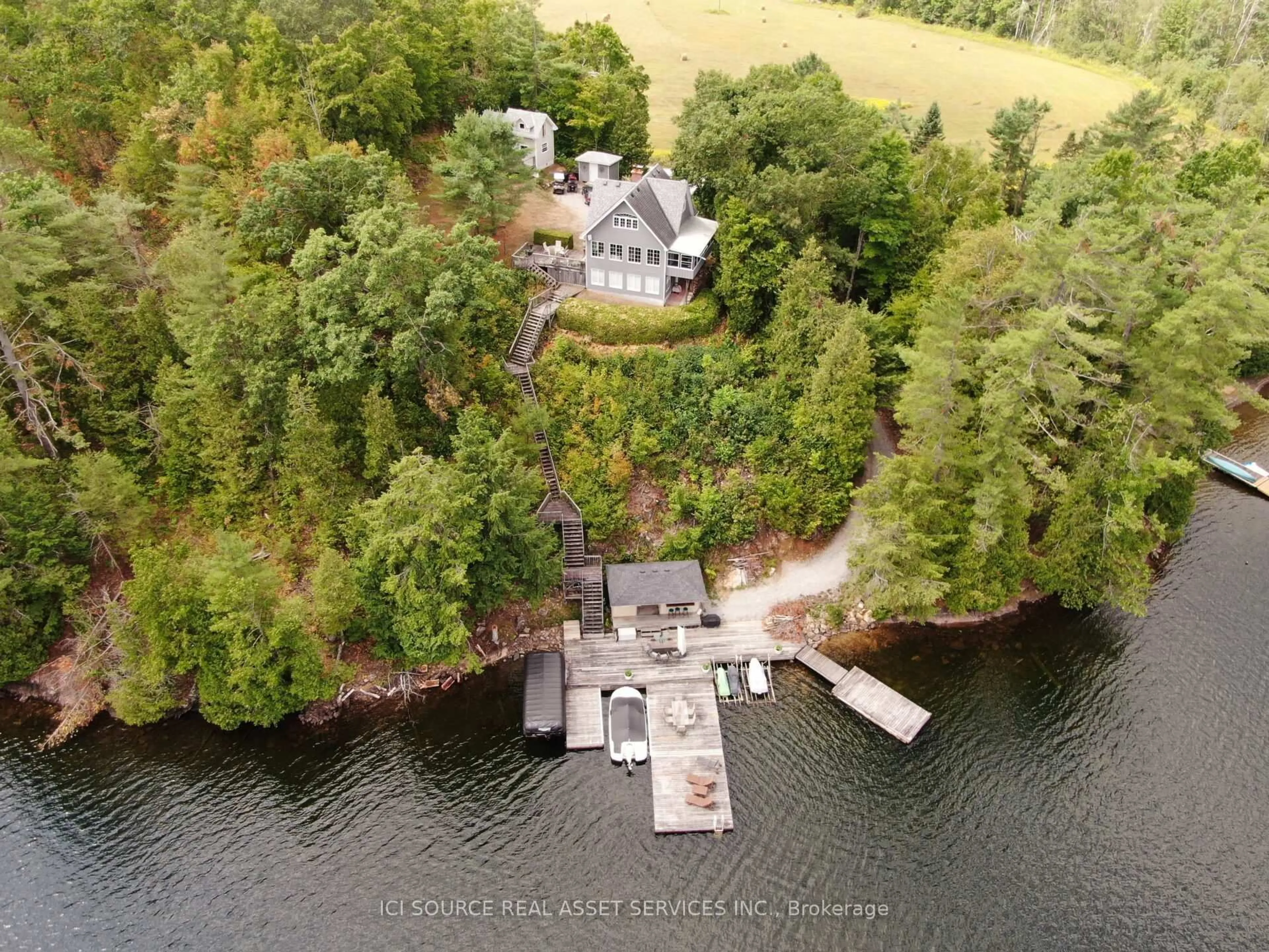 A pic from outside/outdoor area/front of a property/back of a property/a pic from drone, water/lake/river/ocean view for 1096 Lois Lane, Minden Hills Ontario K0M 2L1
