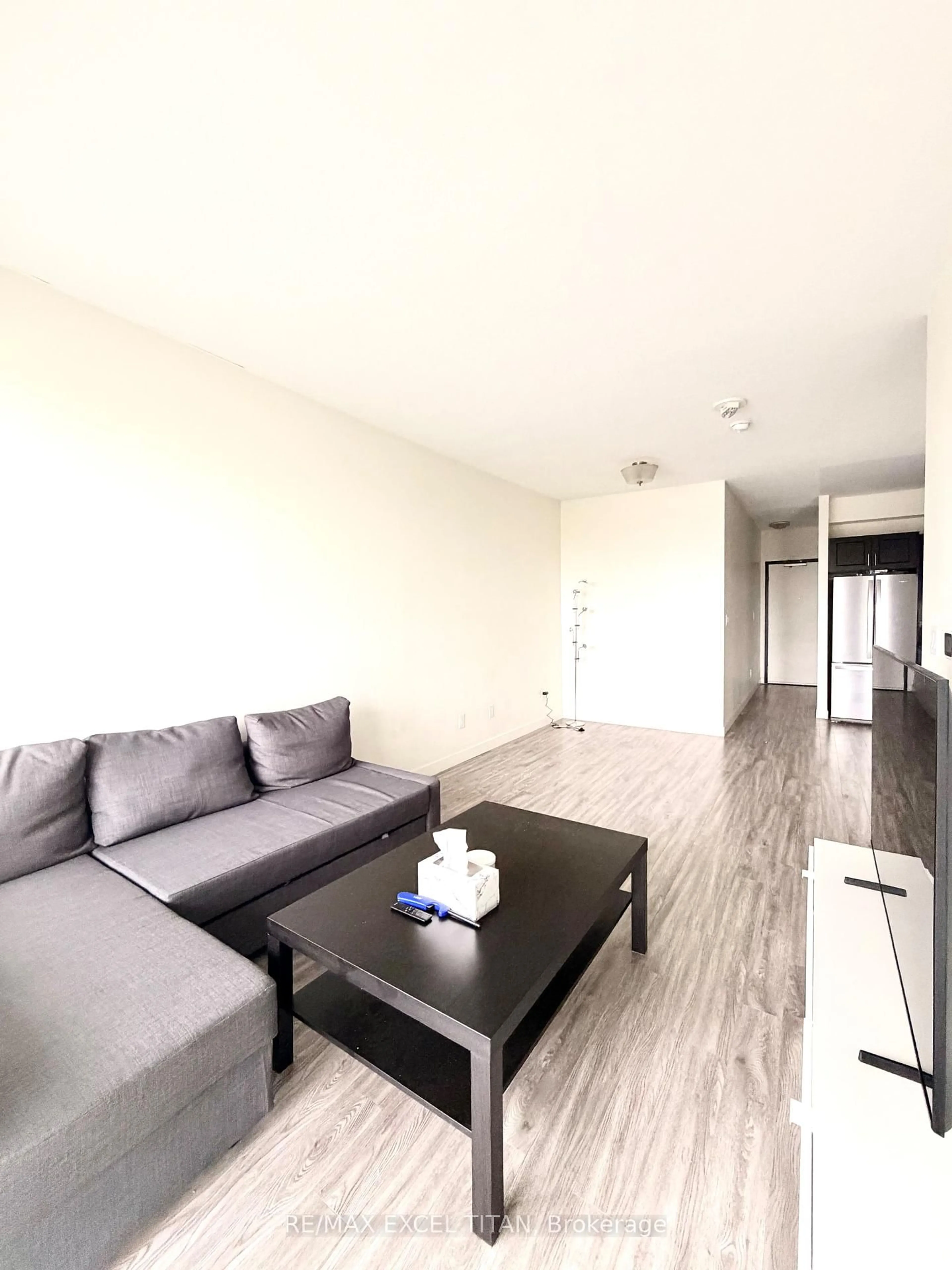 Living room with furniture, wood/laminate floor for 128 King St #703, Waterloo Ontario N2J 0E9