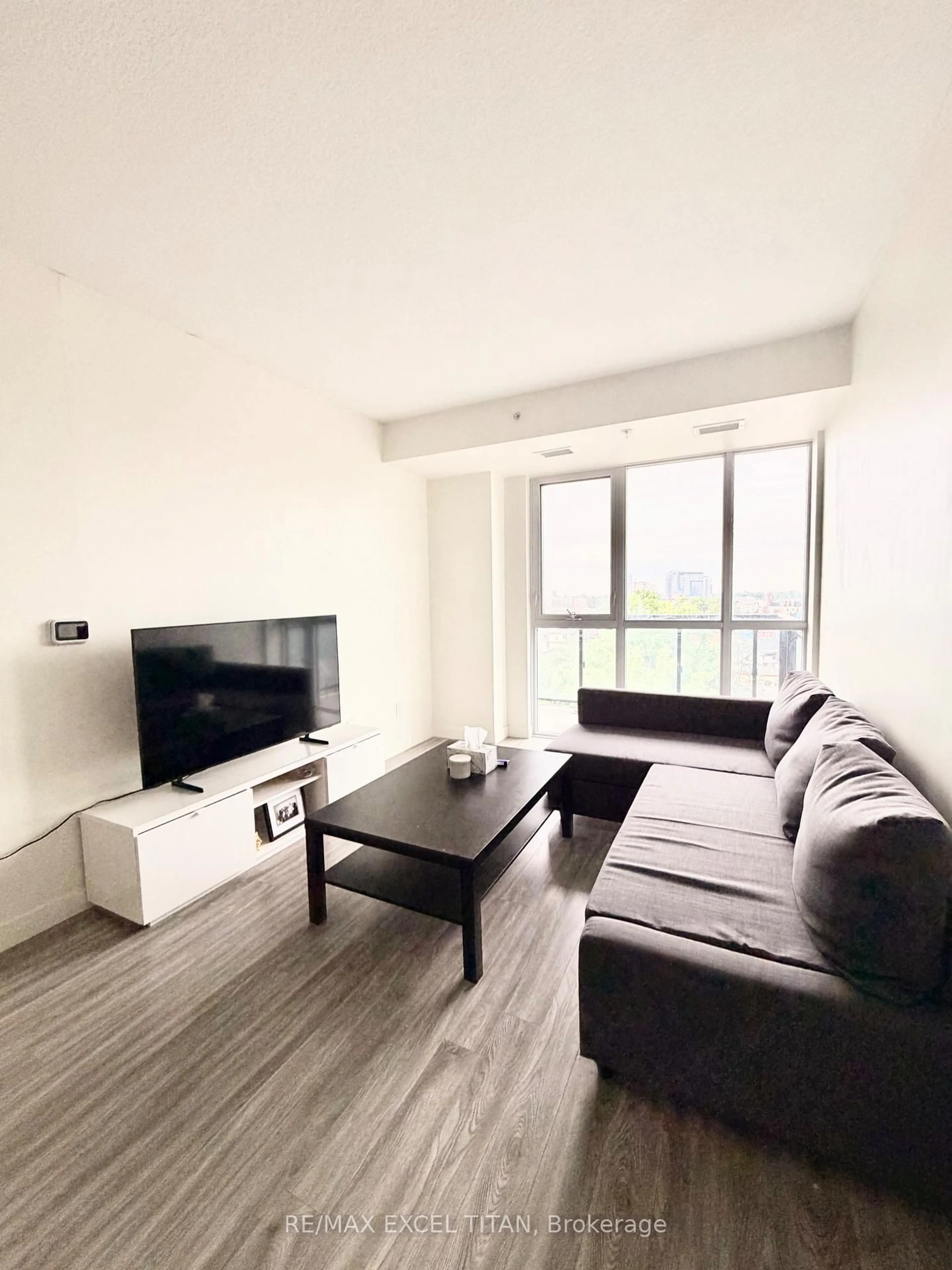 Living room with furniture, wood/laminate floor for 128 King St #703, Waterloo Ontario N2J 0E9