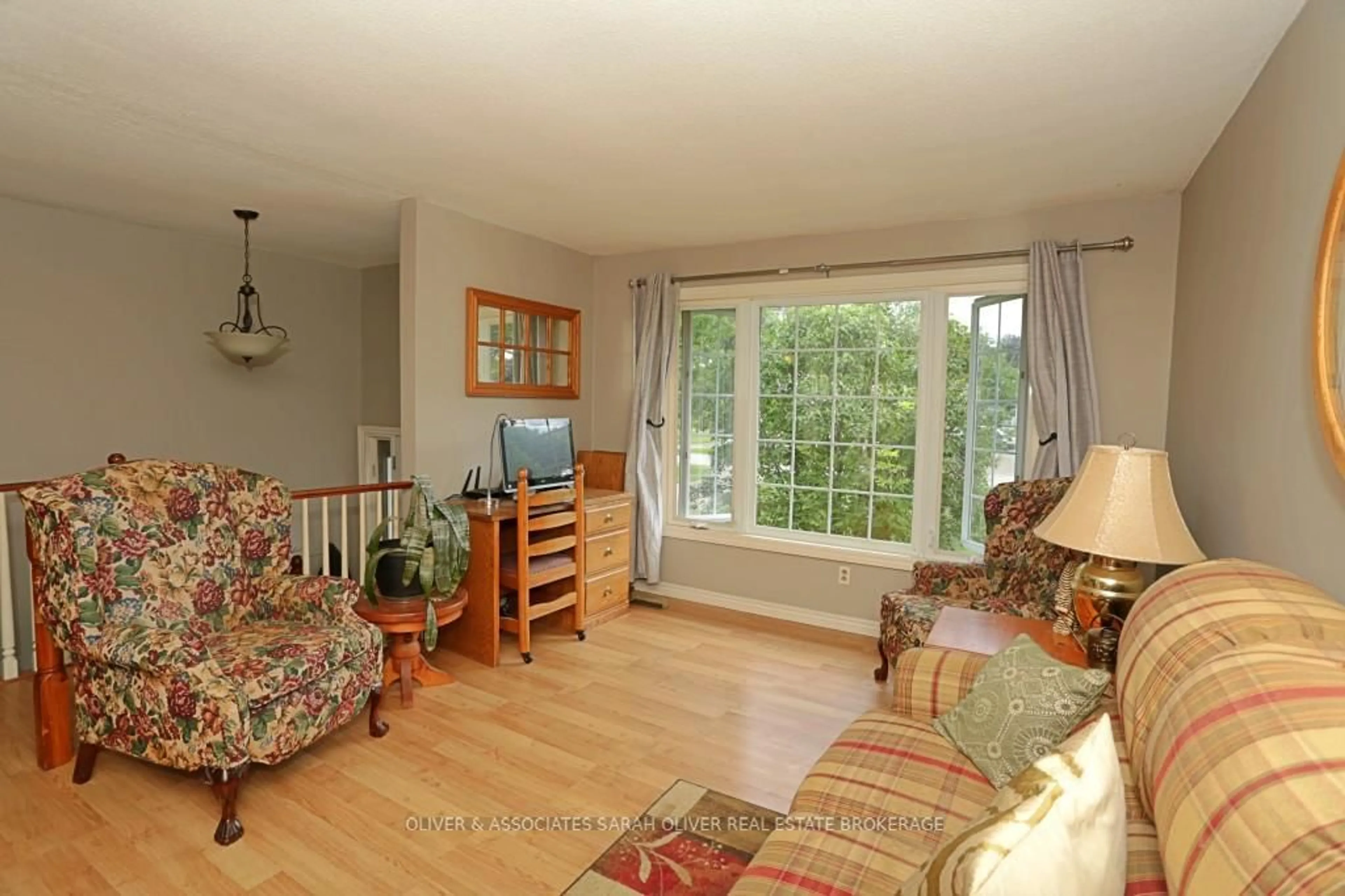 Living room with furniture, wood/laminate floor for 9931 Prince Phillip St, Lambton Shores Ontario N0M 2N0