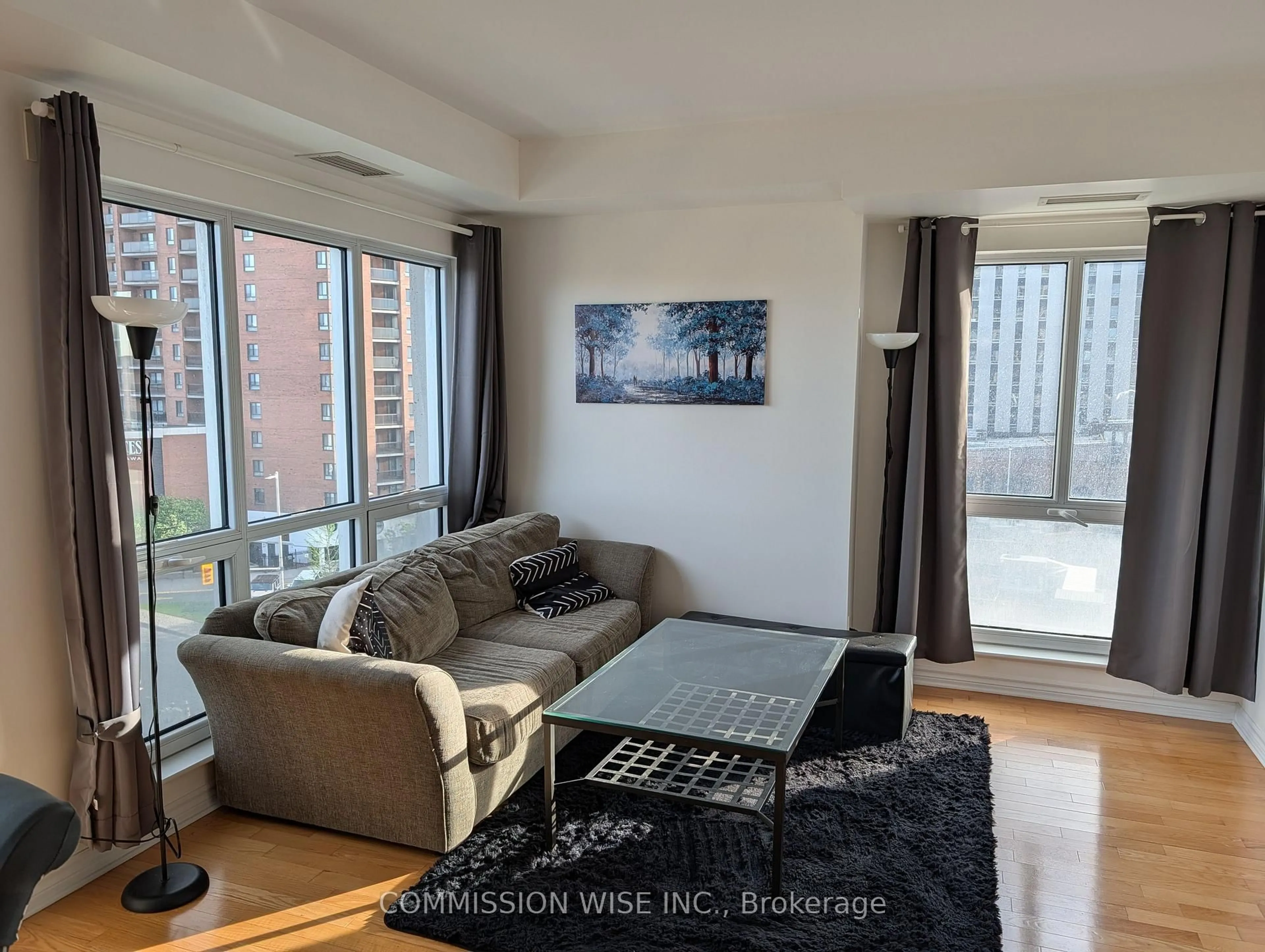 Living room with furniture, wood/laminate floor for 200 Rideau St #708, Ottawa Ontario K1N 5Y1