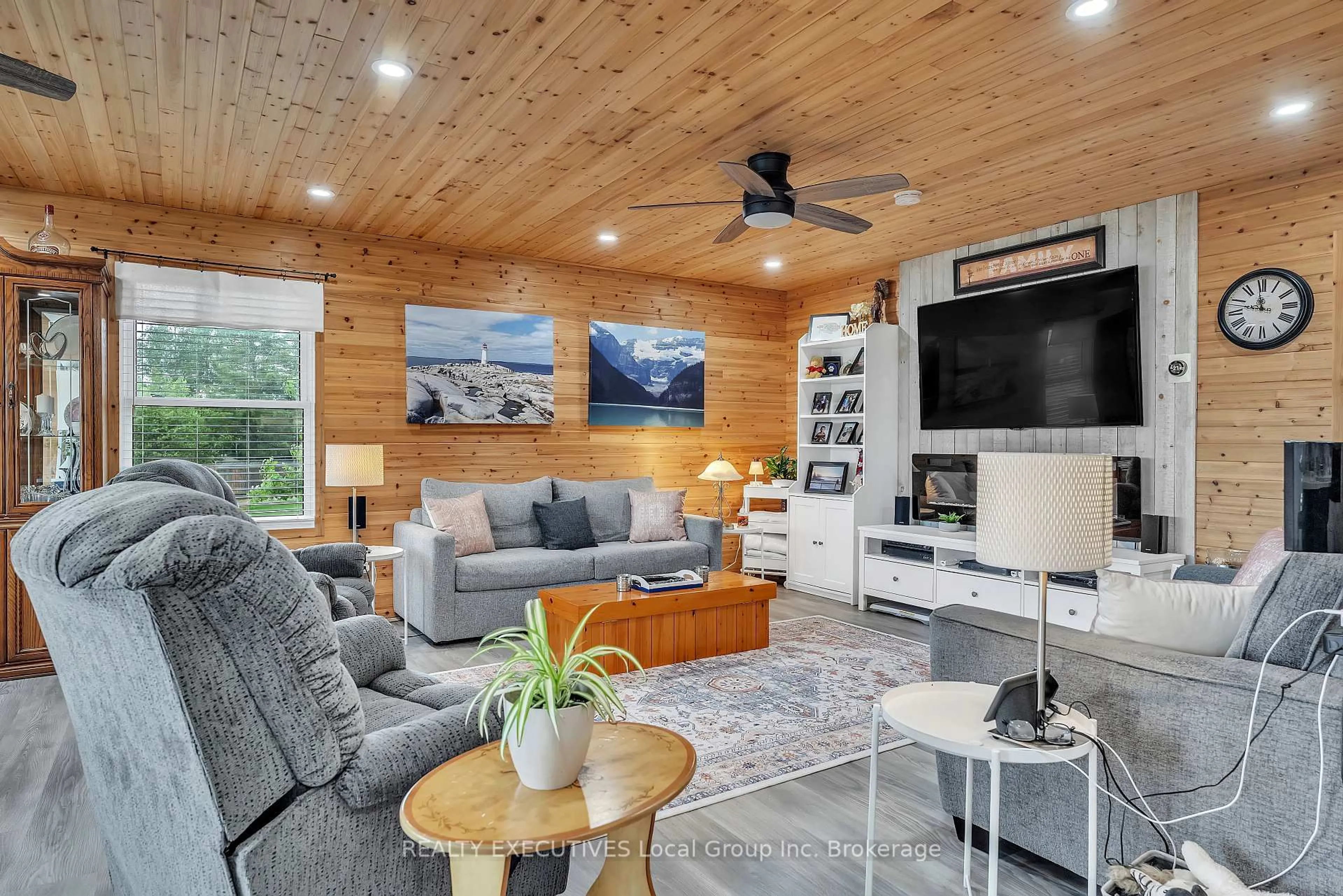 Living room with furniture, wood/laminate floor for 44 Lakeshore Rd, Bonfield Ontario P0H 1E0