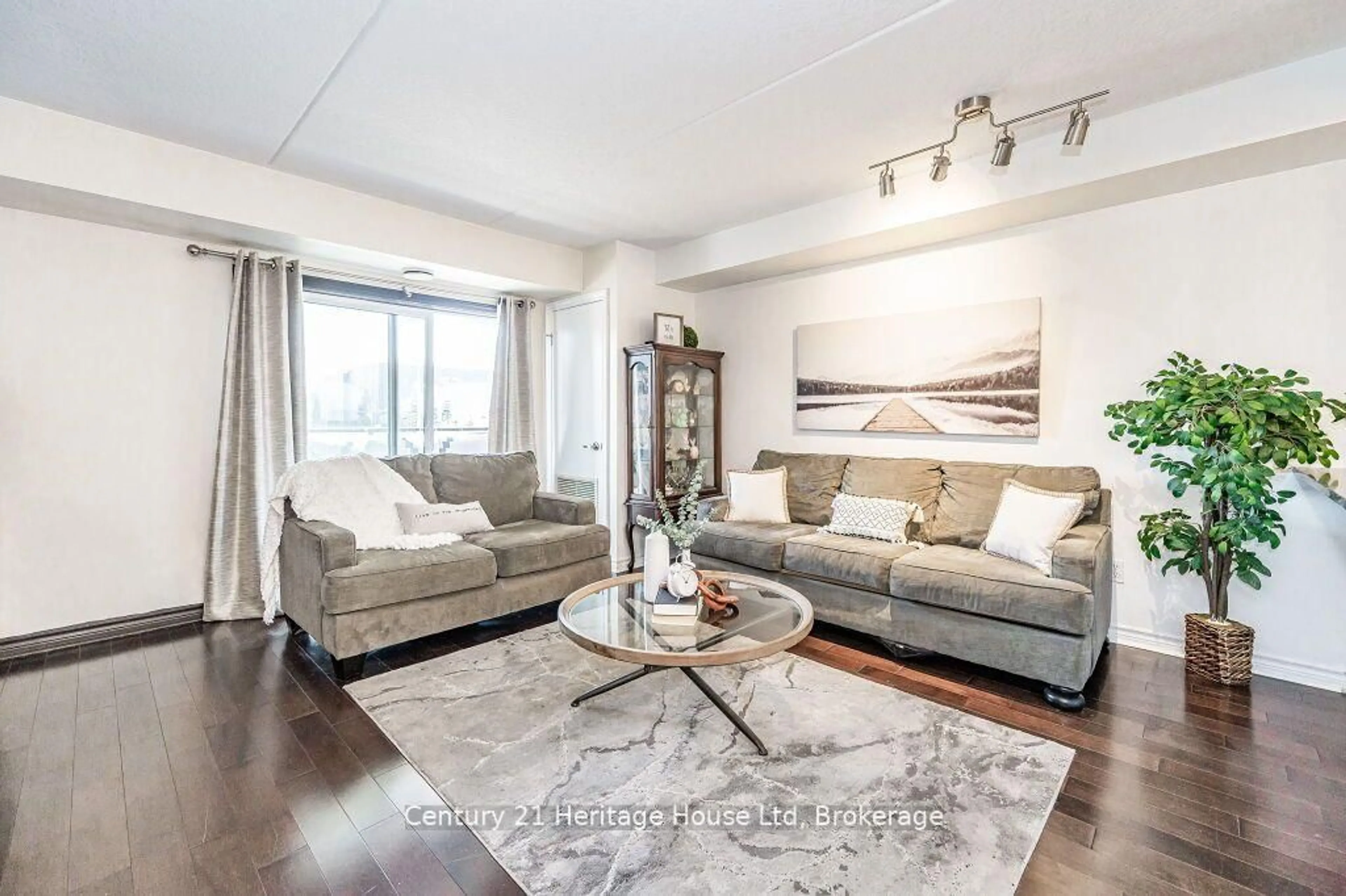 Living room with furniture, wood/laminate floor for 43 Goodwin Dr #212, Guelph Ontario N1L 0E5