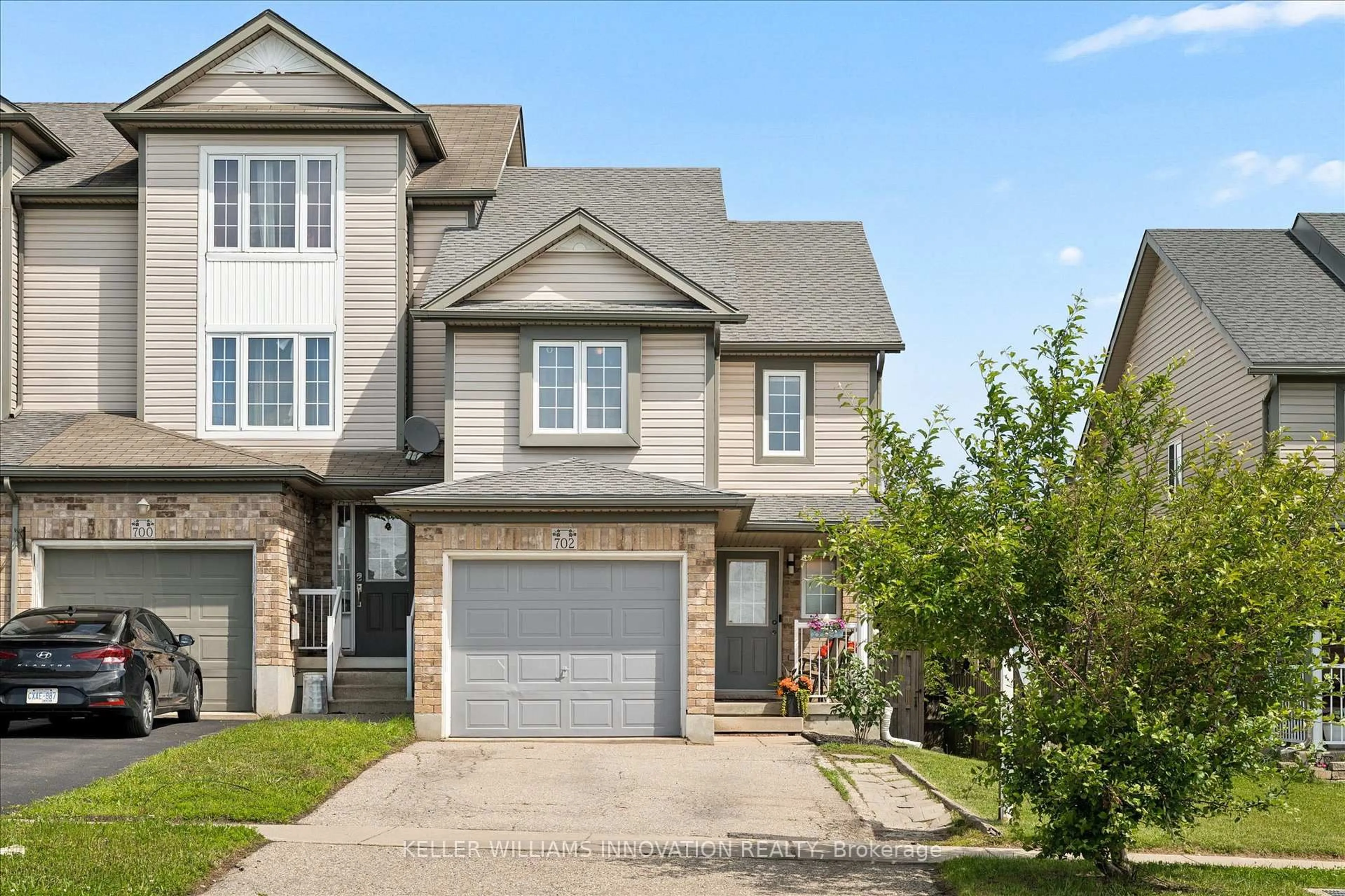 Home with brick exterior material, street for 702 Activa Ave, Kitchener Ontario N2E 4E1