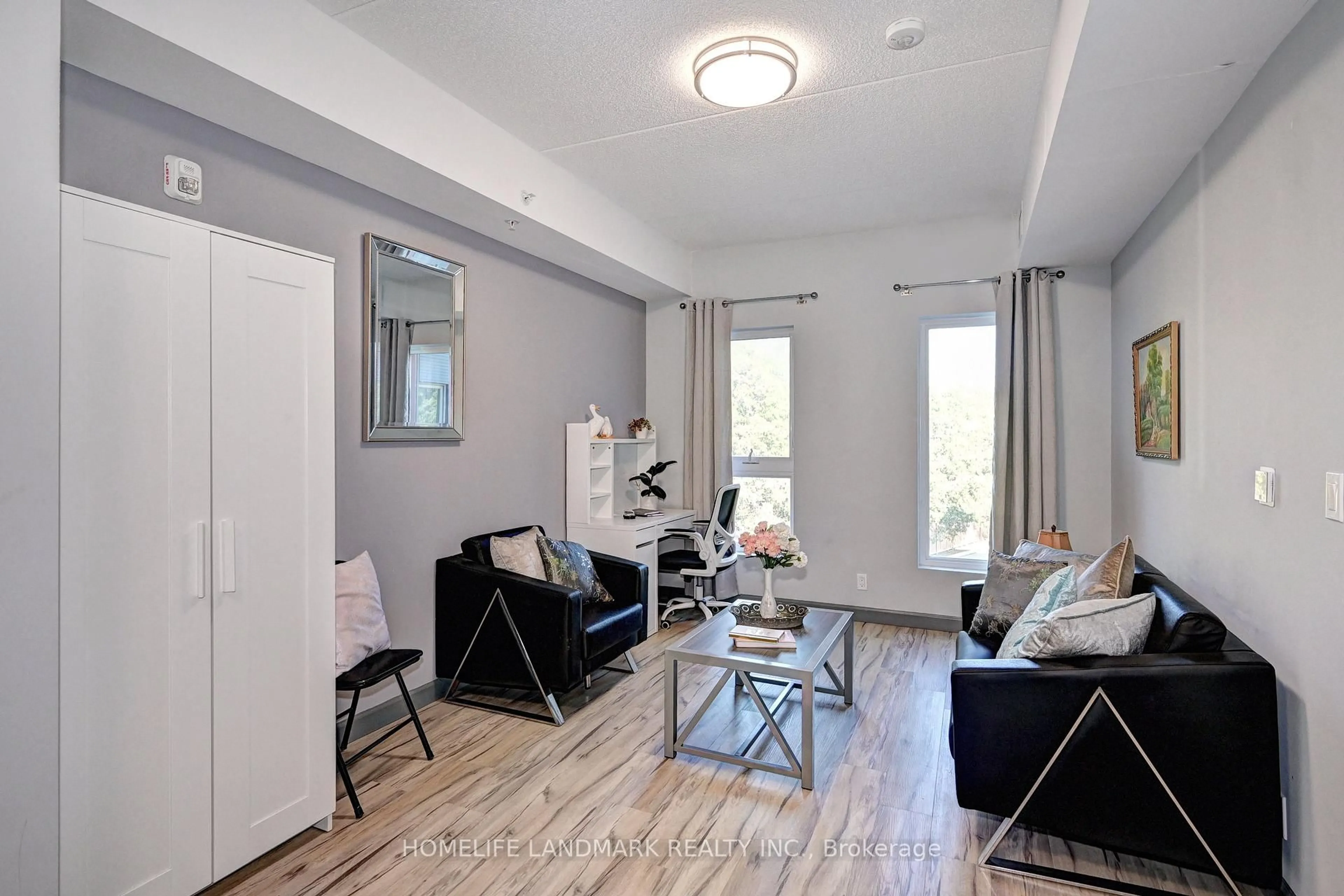 Living room with furniture, wood/laminate floor for 77 Leland St #301, Hamilton Ontario L8S 3A1