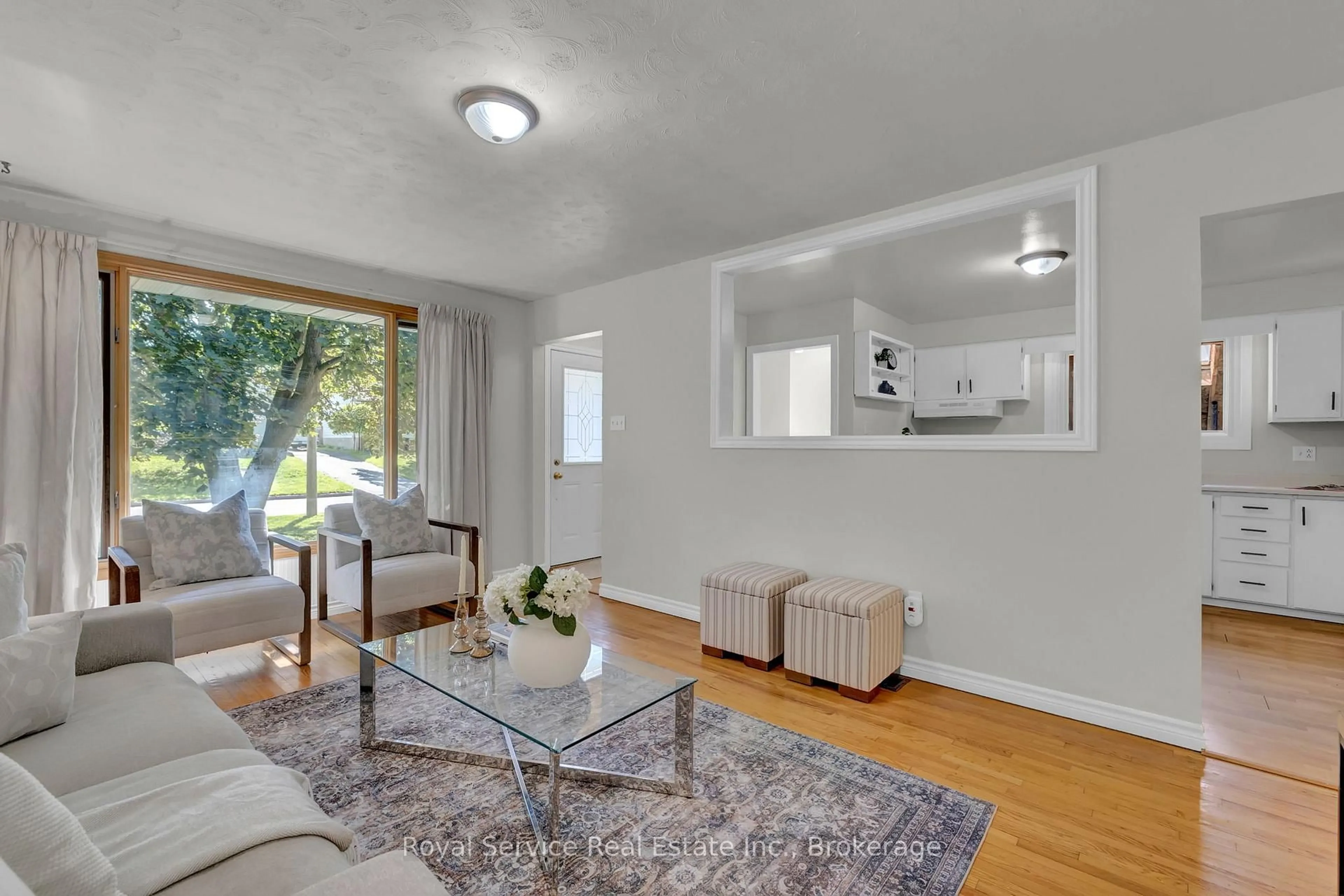 Living room with furniture, wood/laminate floor for 745 Eastdale Crt, Peterborough Ontario K9H 7C6