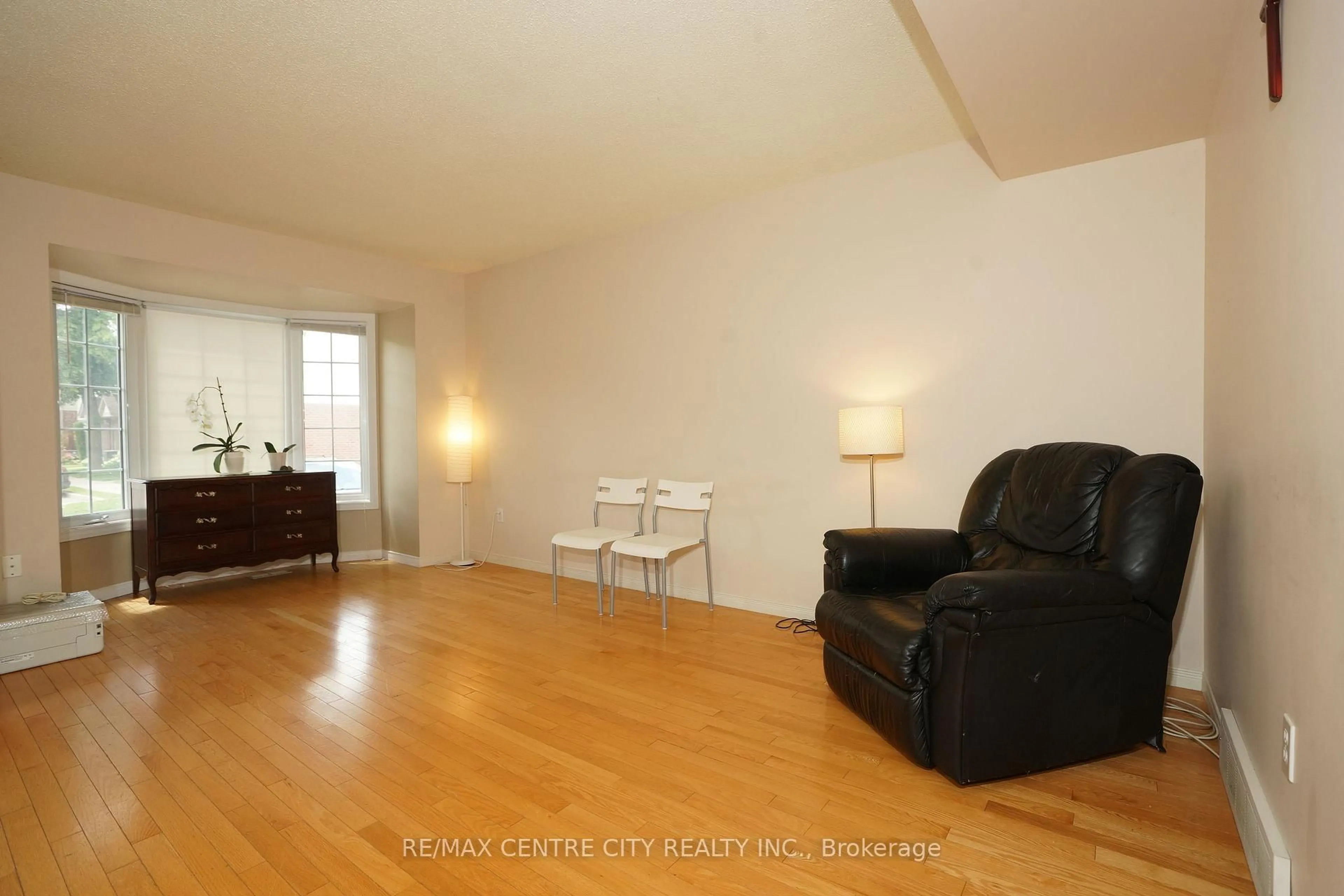 Living room with furniture, wood/laminate floor for 50 Chapman Crt #8, London North Ontario N6G 5E1