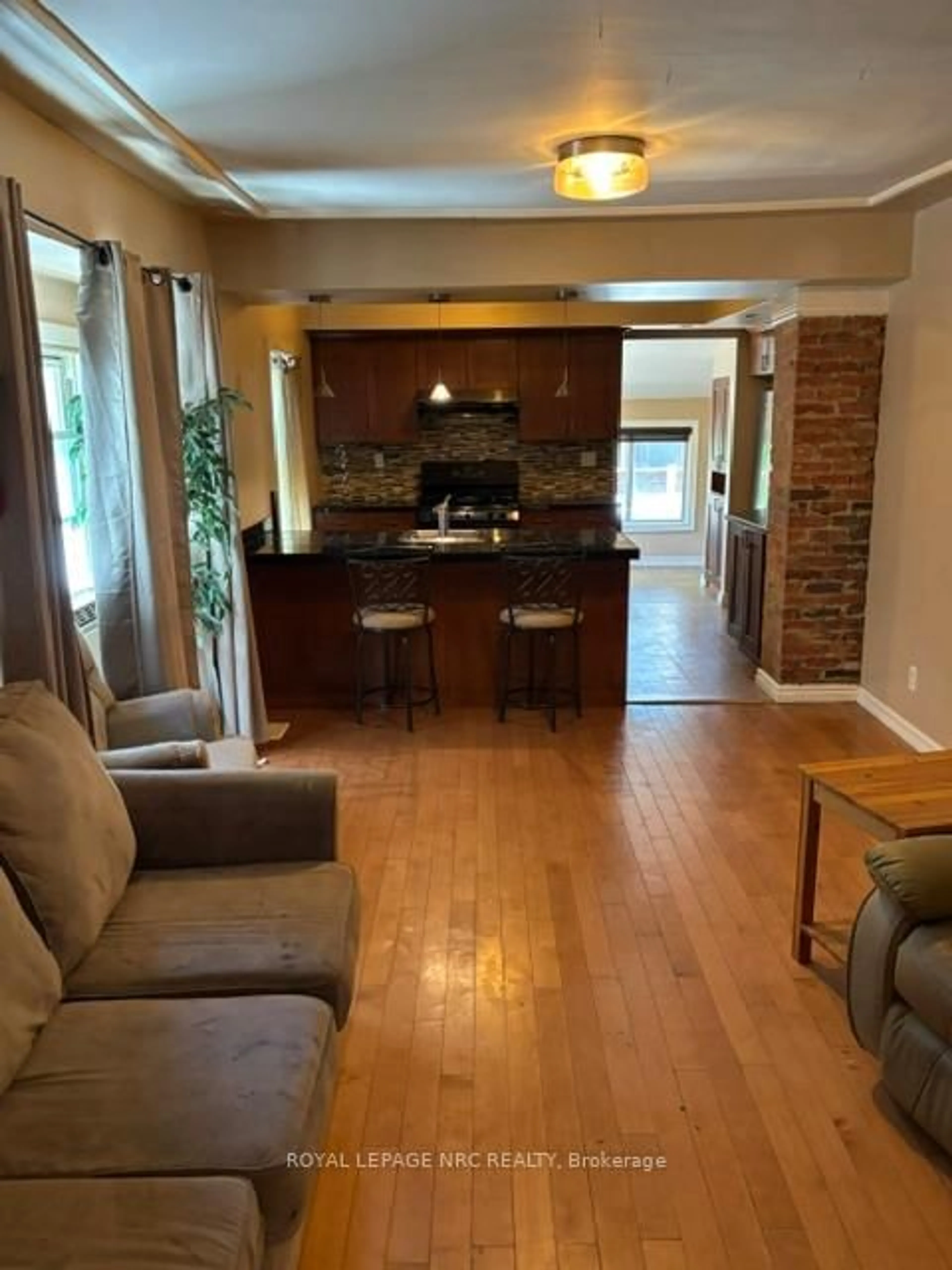 Living room with furniture, wood/laminate floor for 15 Rodman St, St. Catharines Ontario L2R 5C9