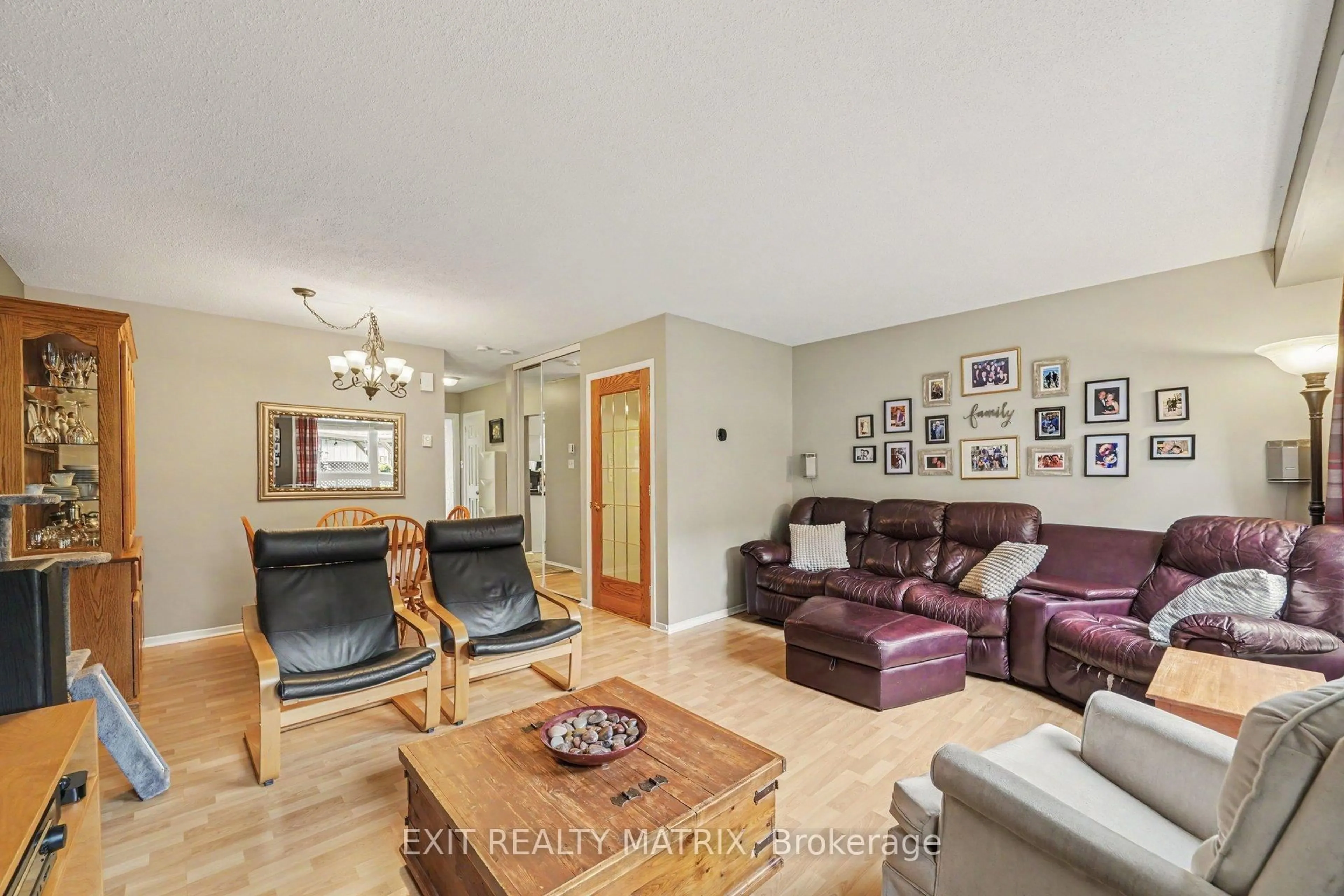 Living room with furniture, wood/laminate floor for 3194 Olympic Way #107, Ottawa Ontario K1T 1Z1