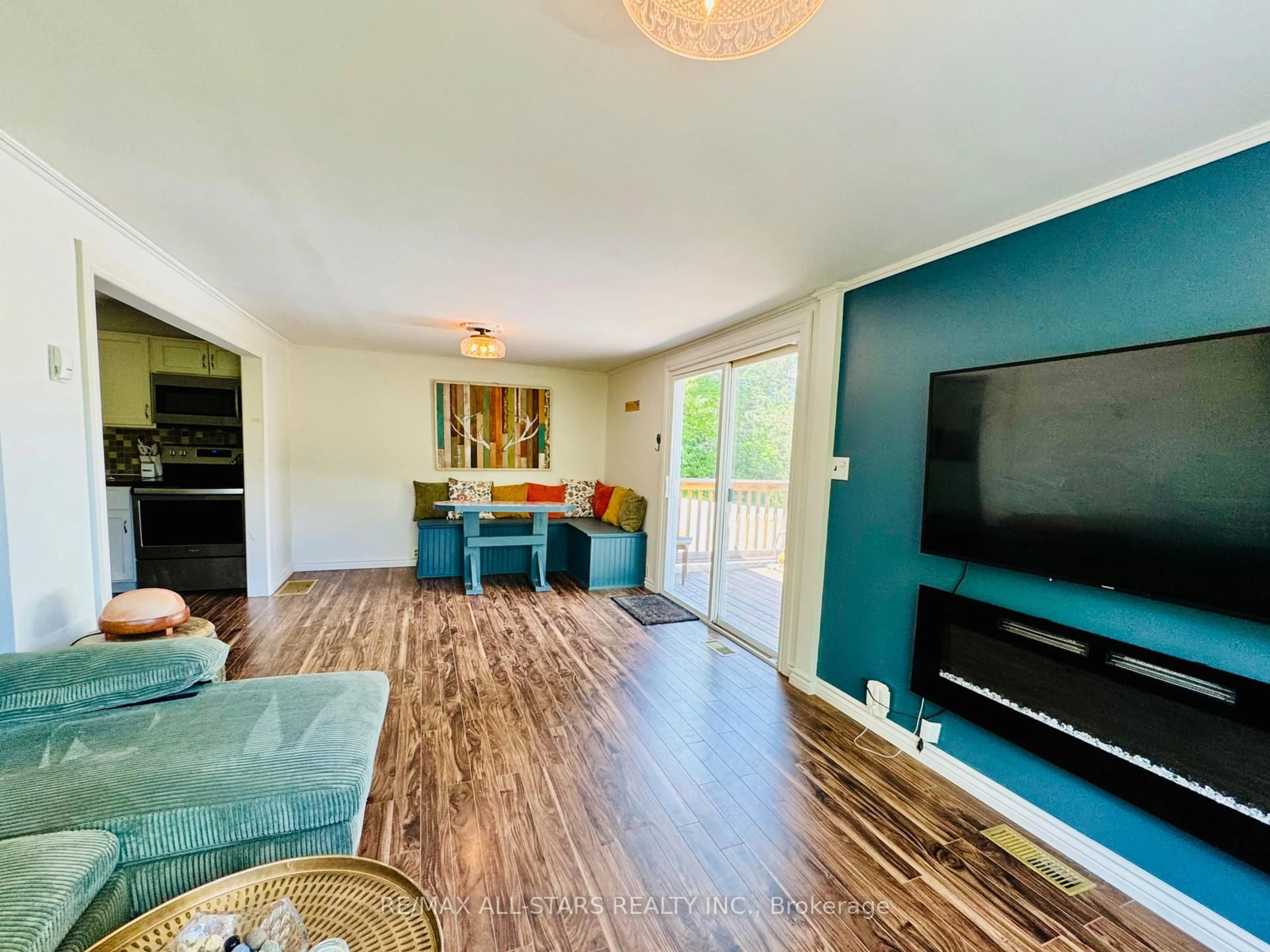 Living room with furniture, wood/laminate floor for 9 Pritchard Rd, Combermere Ontario K0J 1L0