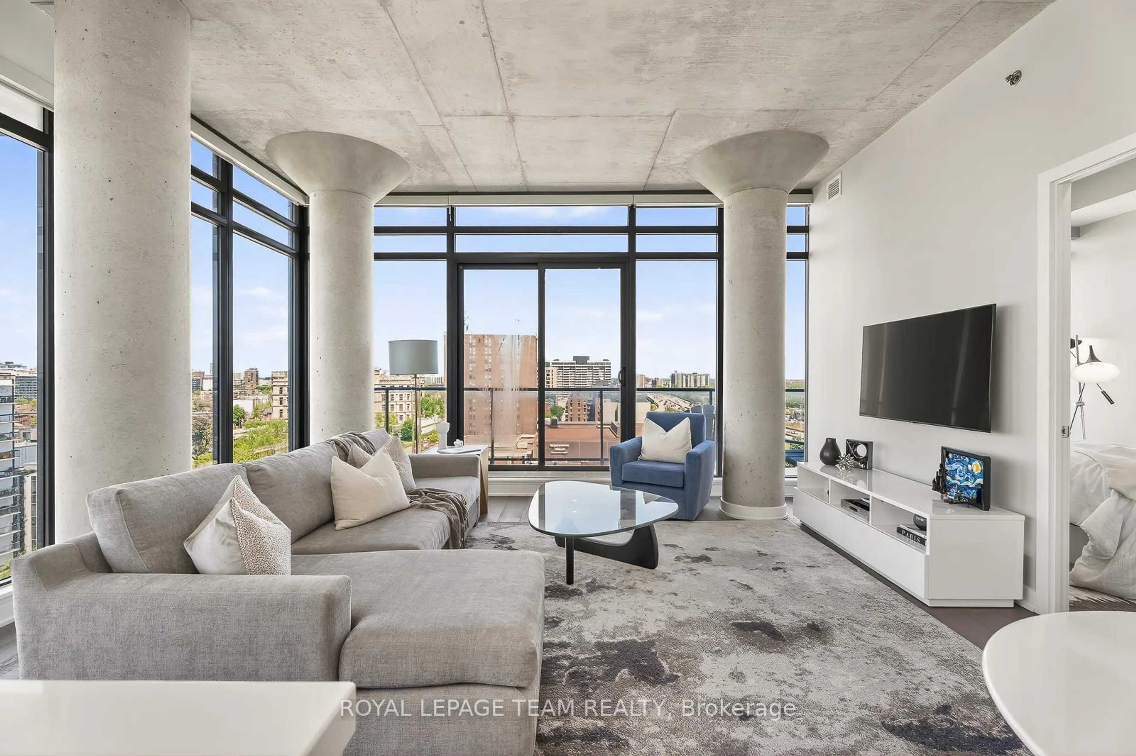 Living room with furniture, cement floor for 203 CATHERINE St #1009, Ottawa Ontario K2P 1J5