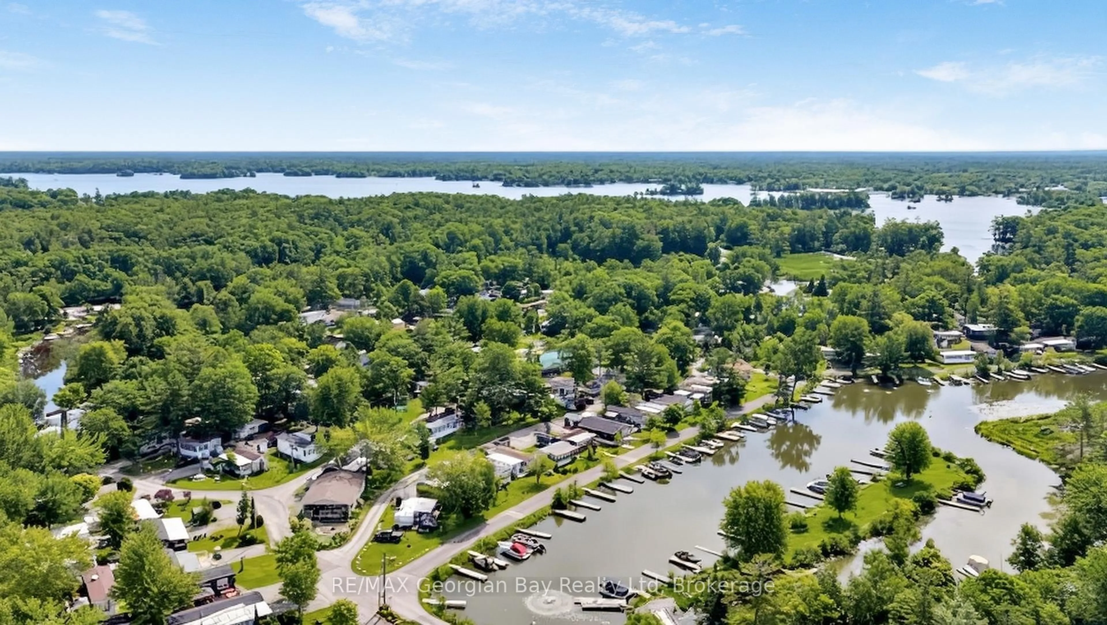 A pic from outside/outdoor area/front of a property/back of a property/a pic from drone, water/lake/river/ocean view for 164 Lone Pine Rd #84, Georgian Bay Ontario L0K 1S0