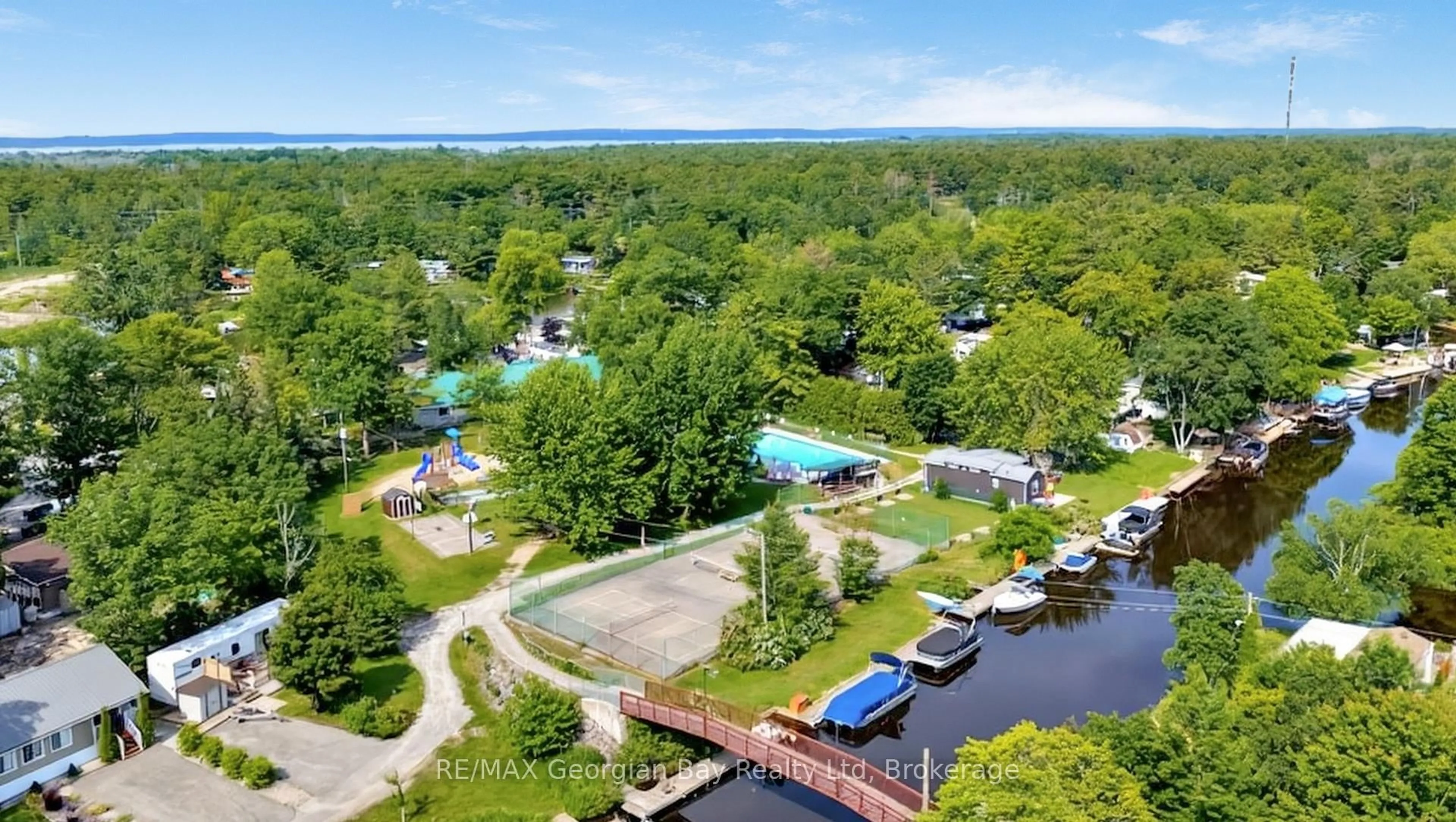 A pic from outside/outdoor area/front of a property/back of a property/a pic from drone, water/lake/river/ocean view for 164 Lone Pine Rd #84, Georgian Bay Ontario L0K 1S0