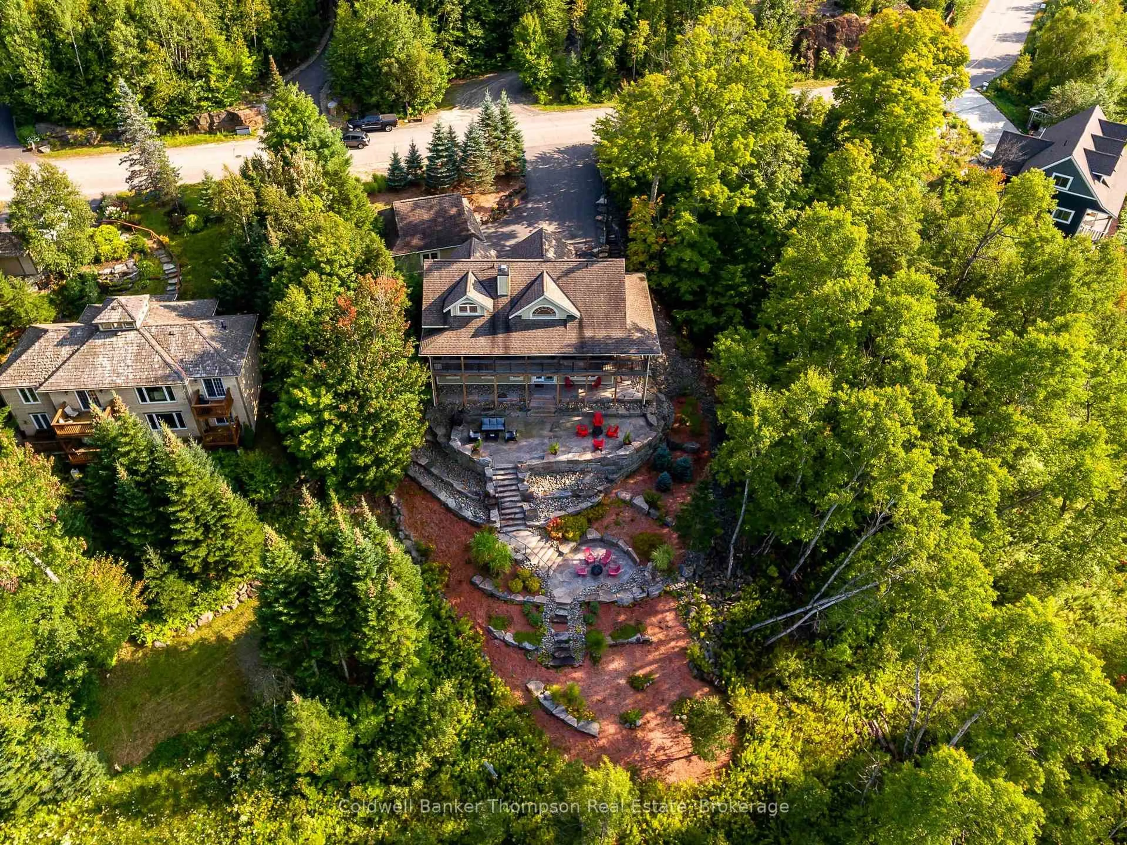 A pic from outside/outdoor area/front of a property/back of a property/a pic from drone, forest/trees view for 21 Deerhurst Highlands Dr, Huntsville Ontario P1H 1B1