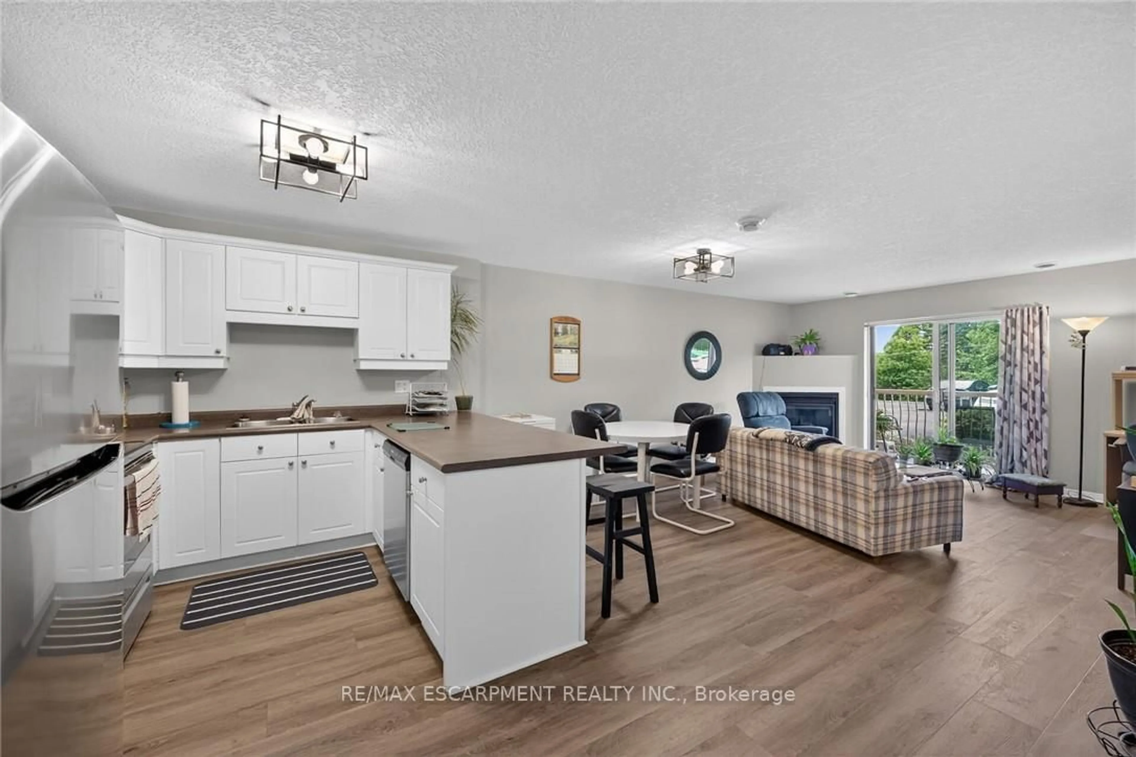 Open concept kitchen, wood/laminate floor for 12 St Andrew St #103, Norfolk Ontario N0A 1N1