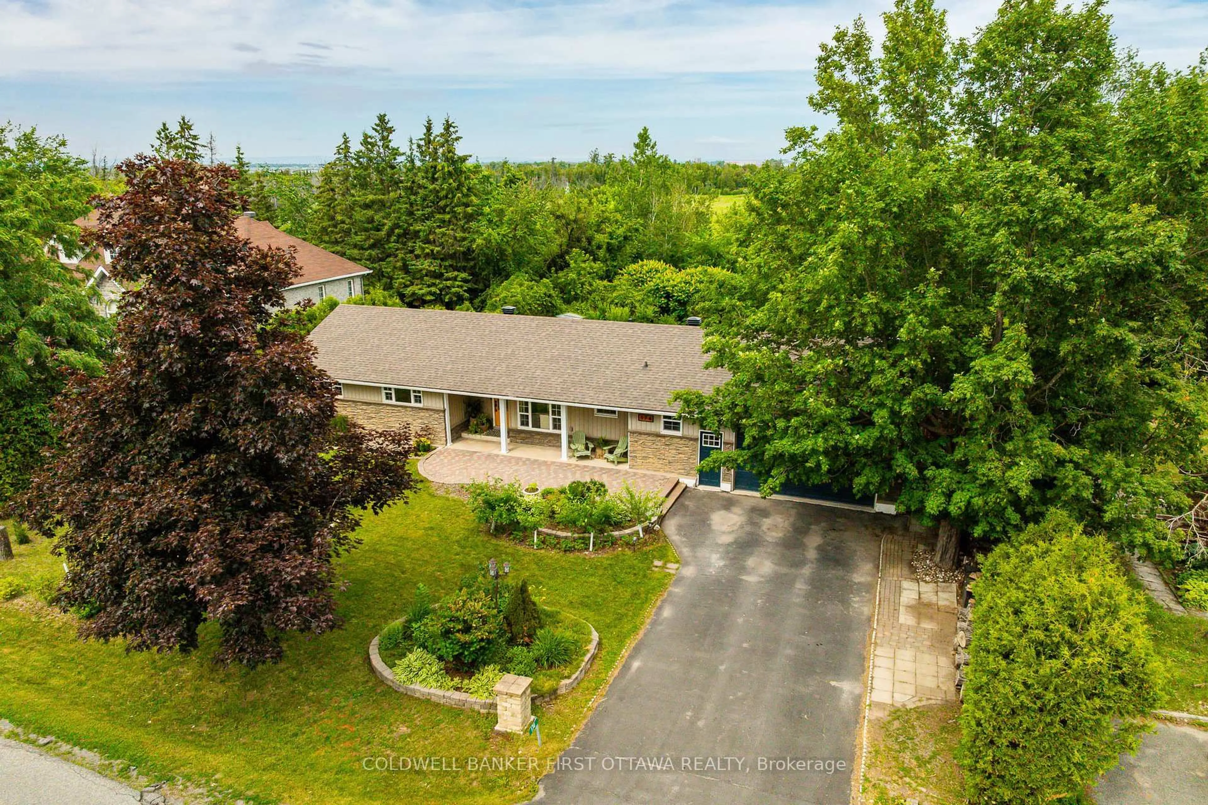 A pic from outside/outdoor area/front of a property/back of a property/a pic from drone, water/lake/river/ocean view for 174 Lloydalex Cres, Carp Ontario K0A 1L0