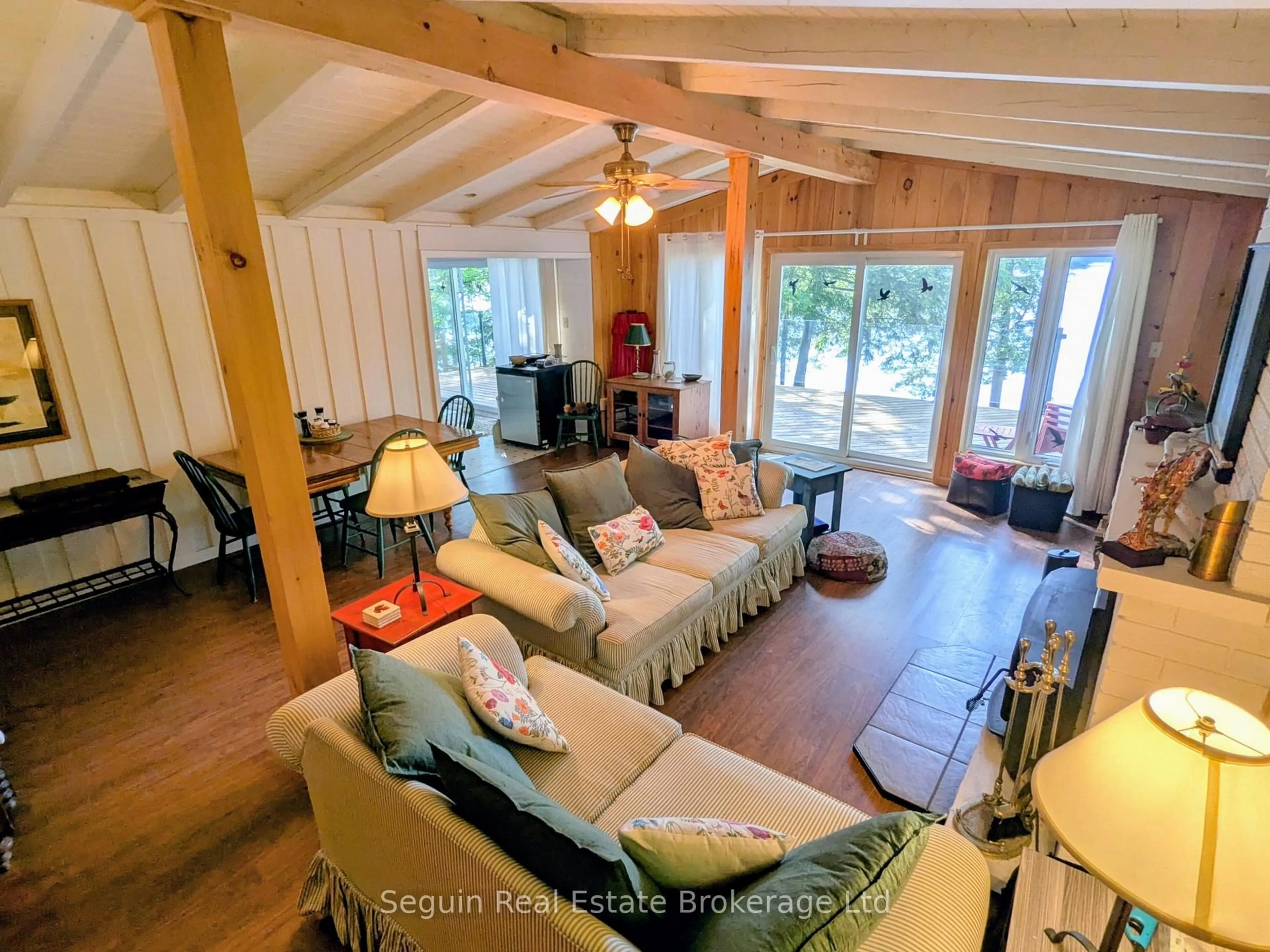 Living room with furniture, wood/laminate floor for 47 Deerfield Rd, McKellar Ontario P2A 2W7