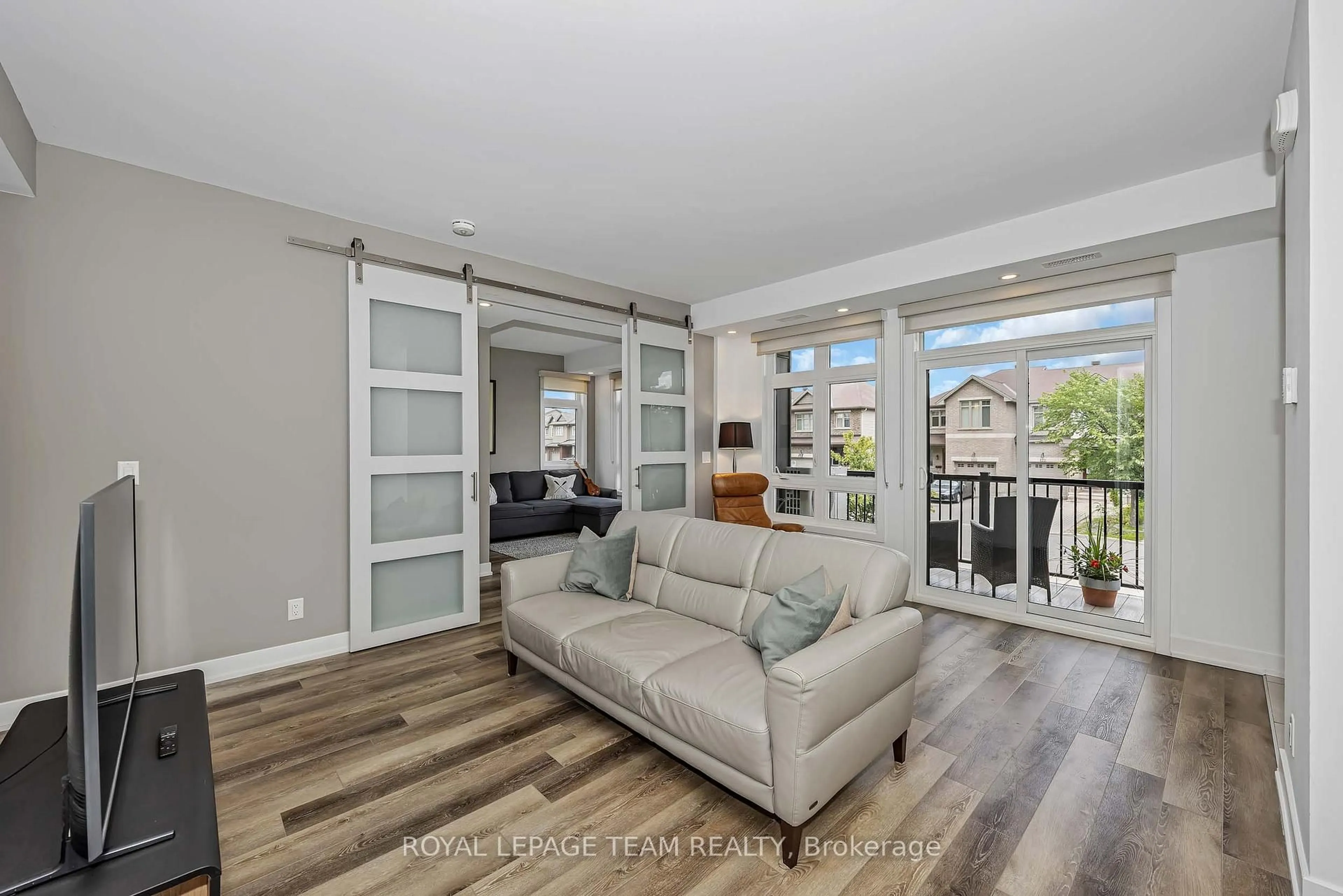 Living room with furniture, wood/laminate floor for 121 Fairweather St, Ottawa Ontario K1T 0M8