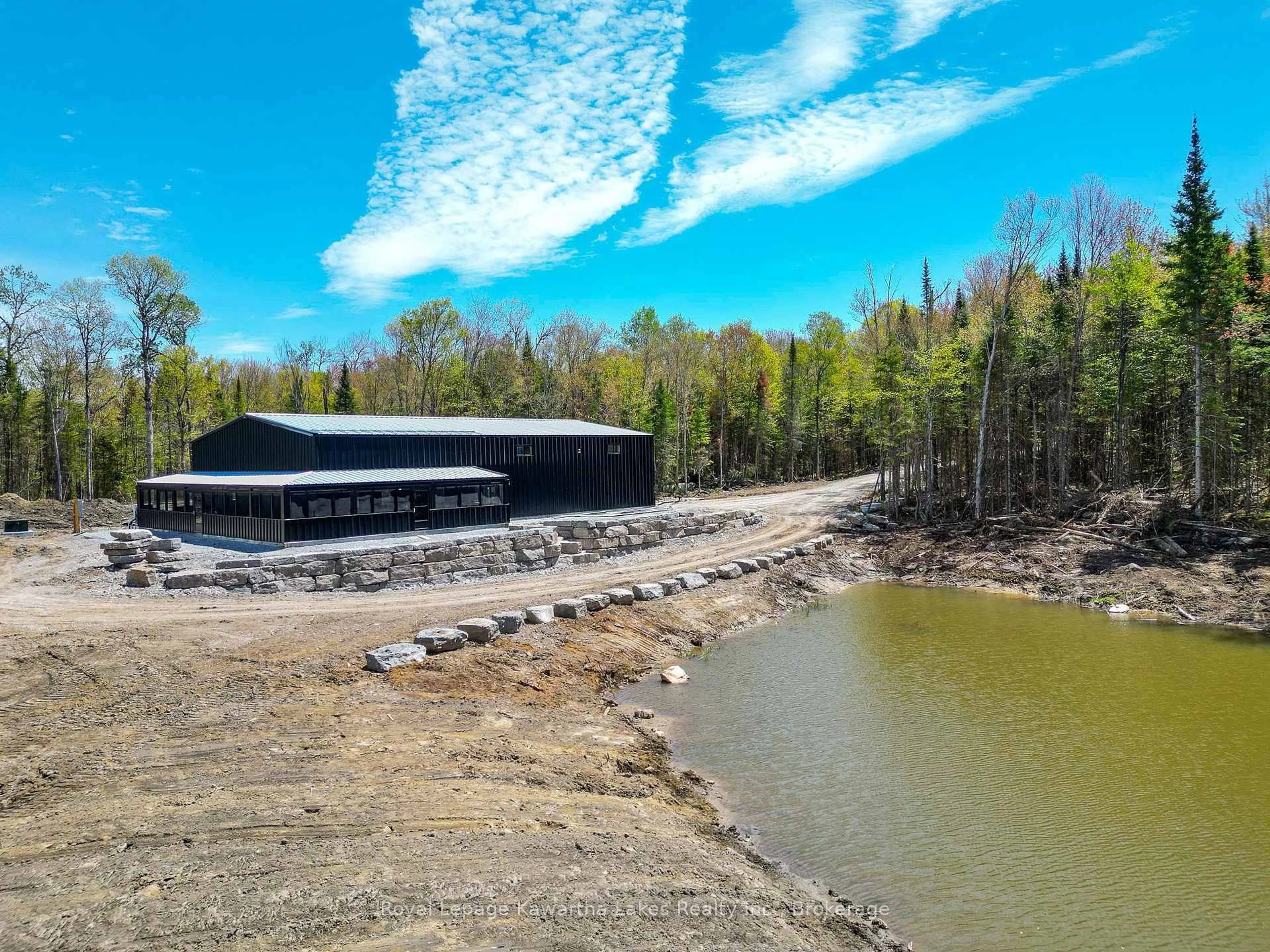 A pic from outside/outdoor area/front of a property/back of a property/a pic from drone, water/lake/river/ocean view for 1851 Contau Lake Rd, Highlands East Ontario K0M 1R0
