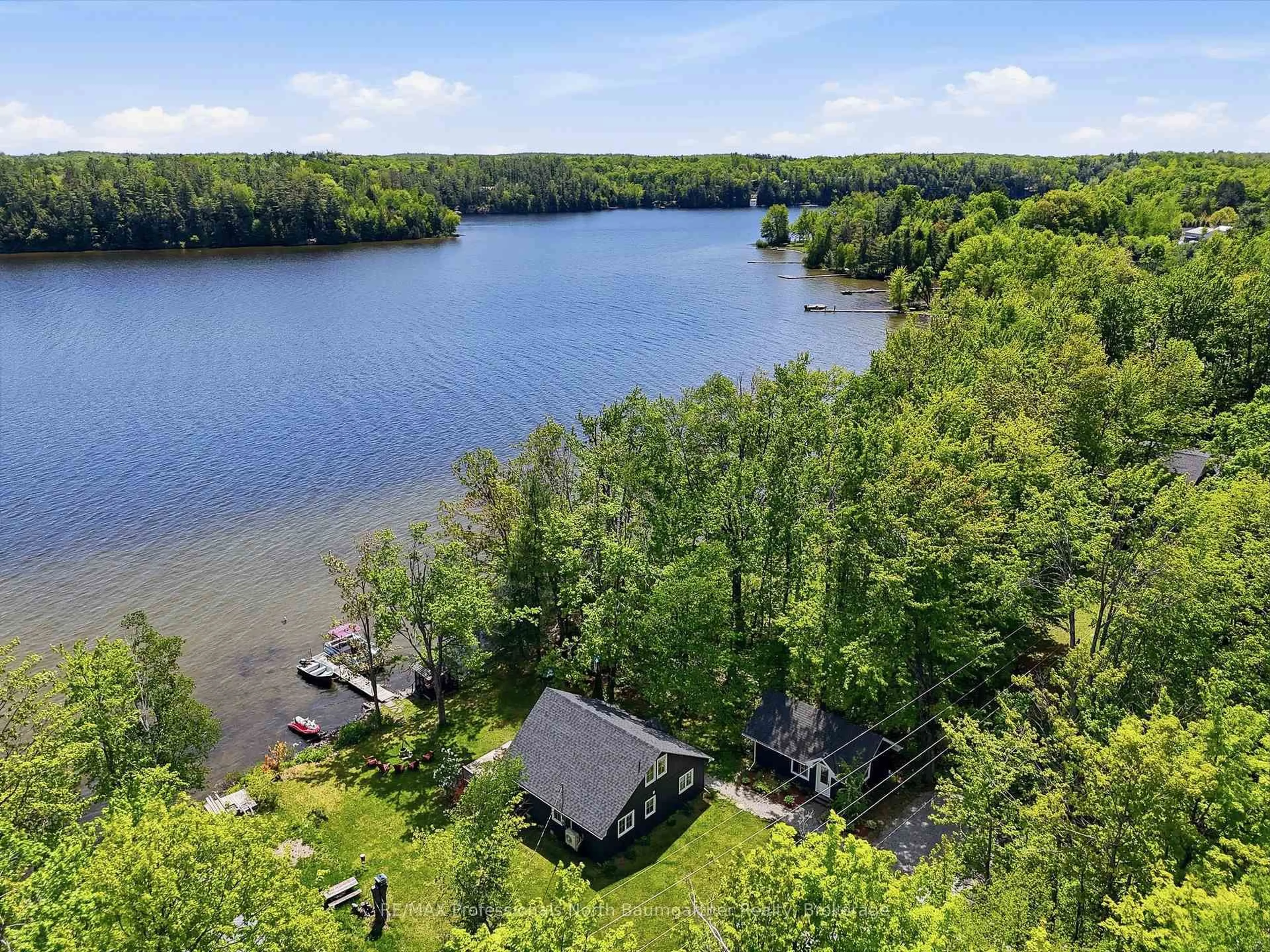 A pic from outside/outdoor area/front of a property/back of a property/a pic from drone, water/lake/river/ocean view for 1033 Poster Lane, Minden Hills Ontario K0M 2K0