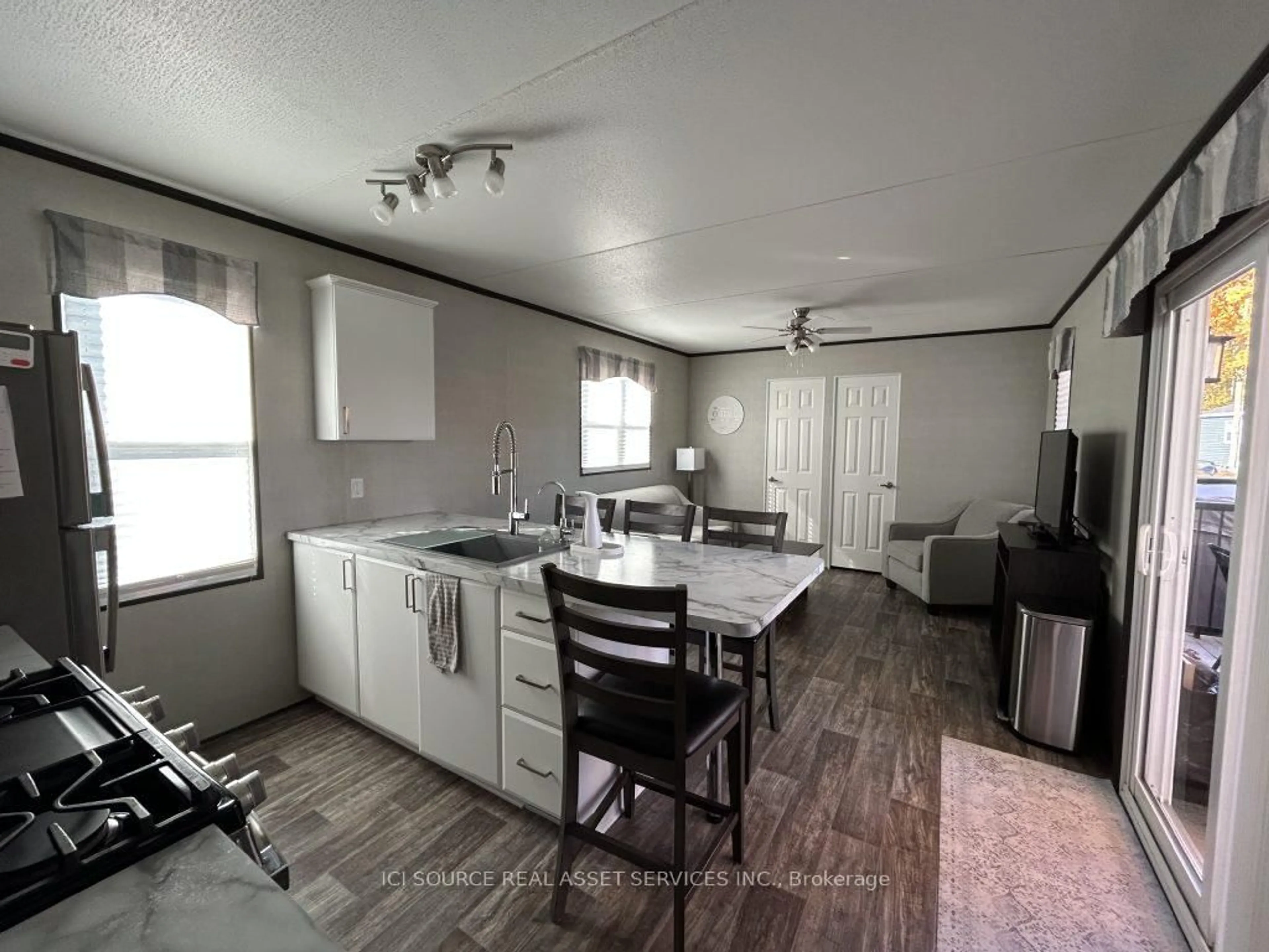 Open concept kitchen, wood/laminate floor for 1235 Villiers Line #CHL027, Otonabee-South Monaghan Ontario K0L 2G0