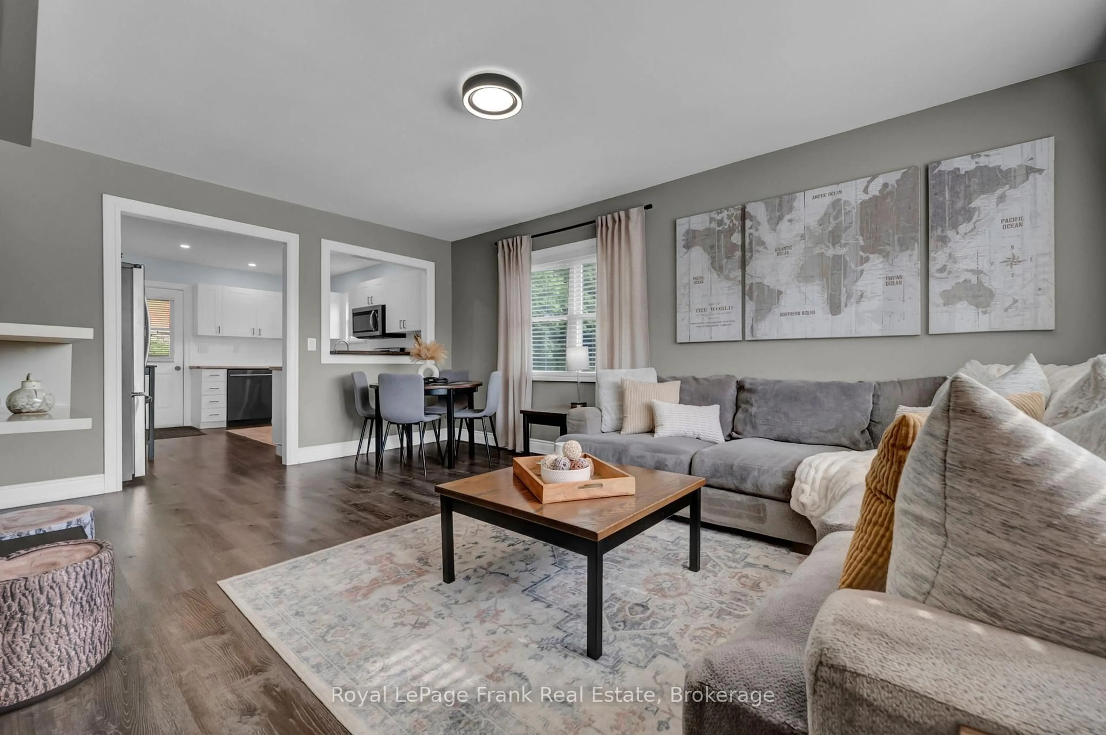 Living room with furniture, wood/laminate floor for 3461 Burnham St, Hamilton Township Ontario K9A 4J7