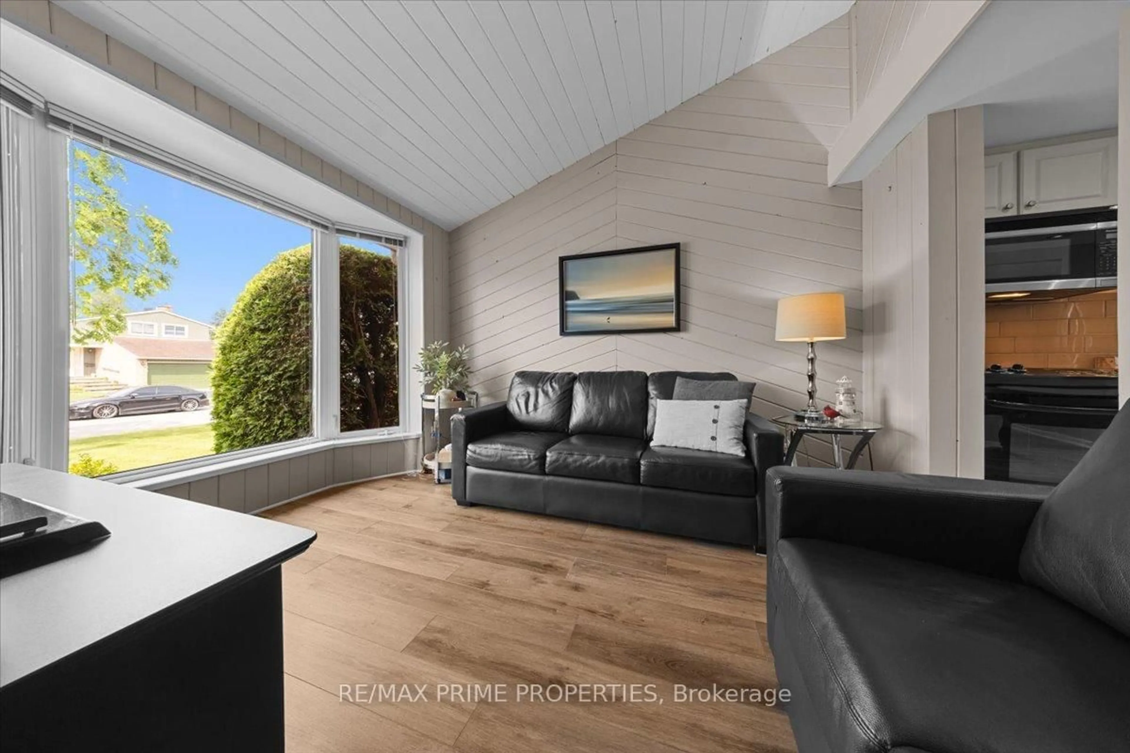 Living room with furniture, wood/laminate floor for 1085 Chateau Cres, Ottawa Ontario K1C 2C9
