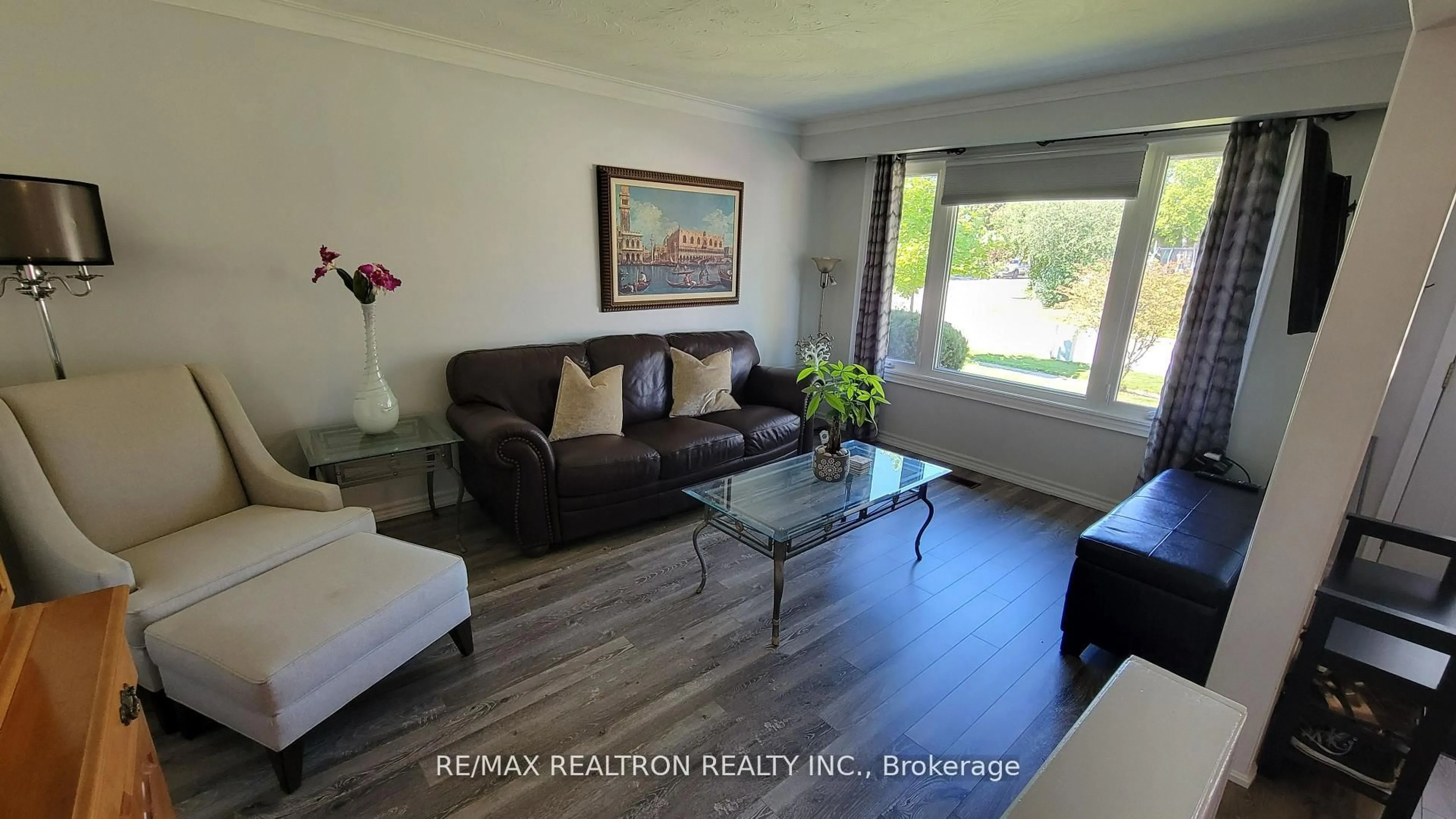 Living room with furniture, wood/laminate floor for 65 Mcilwraith Cres, Guelph Ontario N1E 6J4