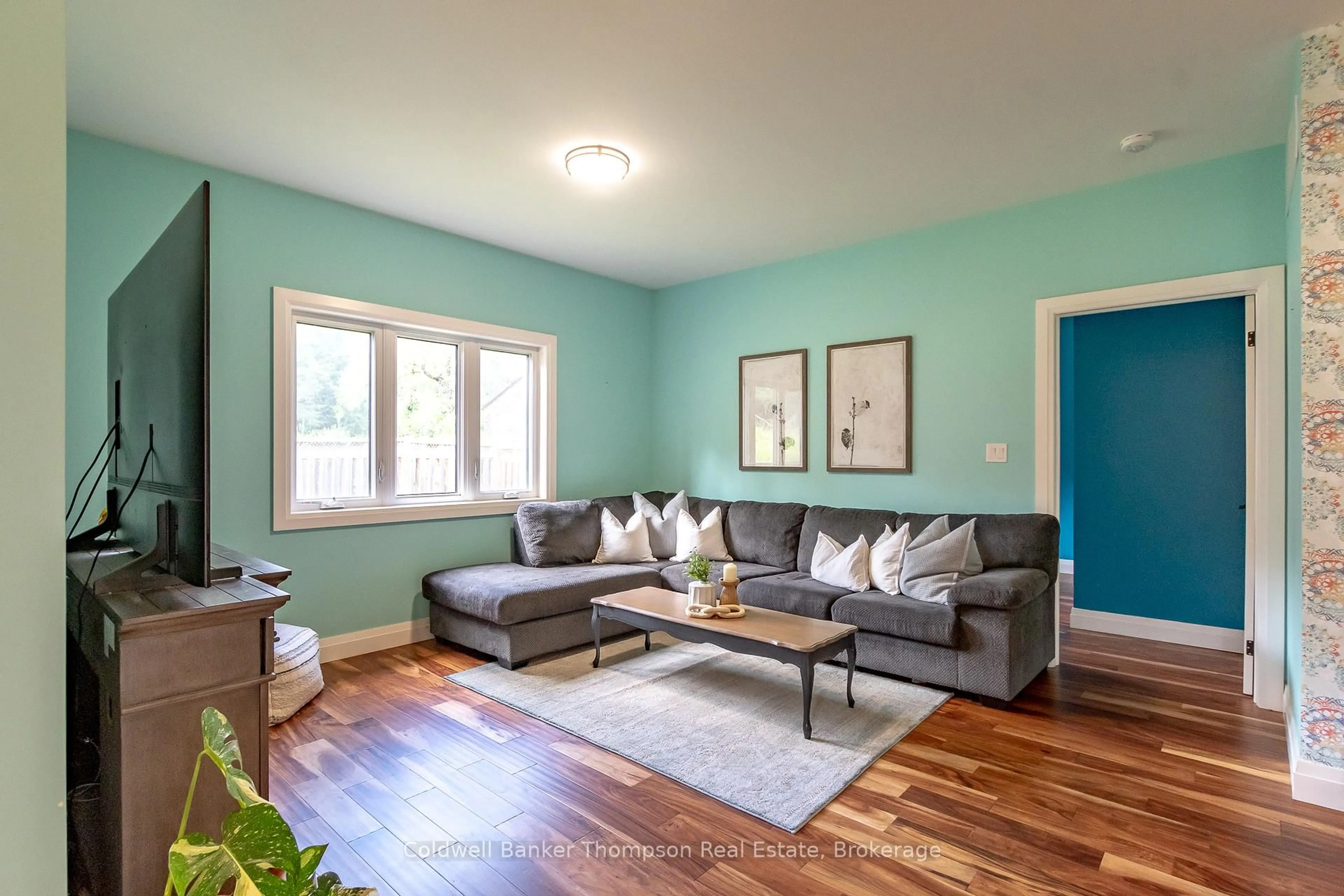 Living room with furniture, wood/laminate floor for 80 Chaffey Township Rd, Huntsville Ontario P1H 1C8