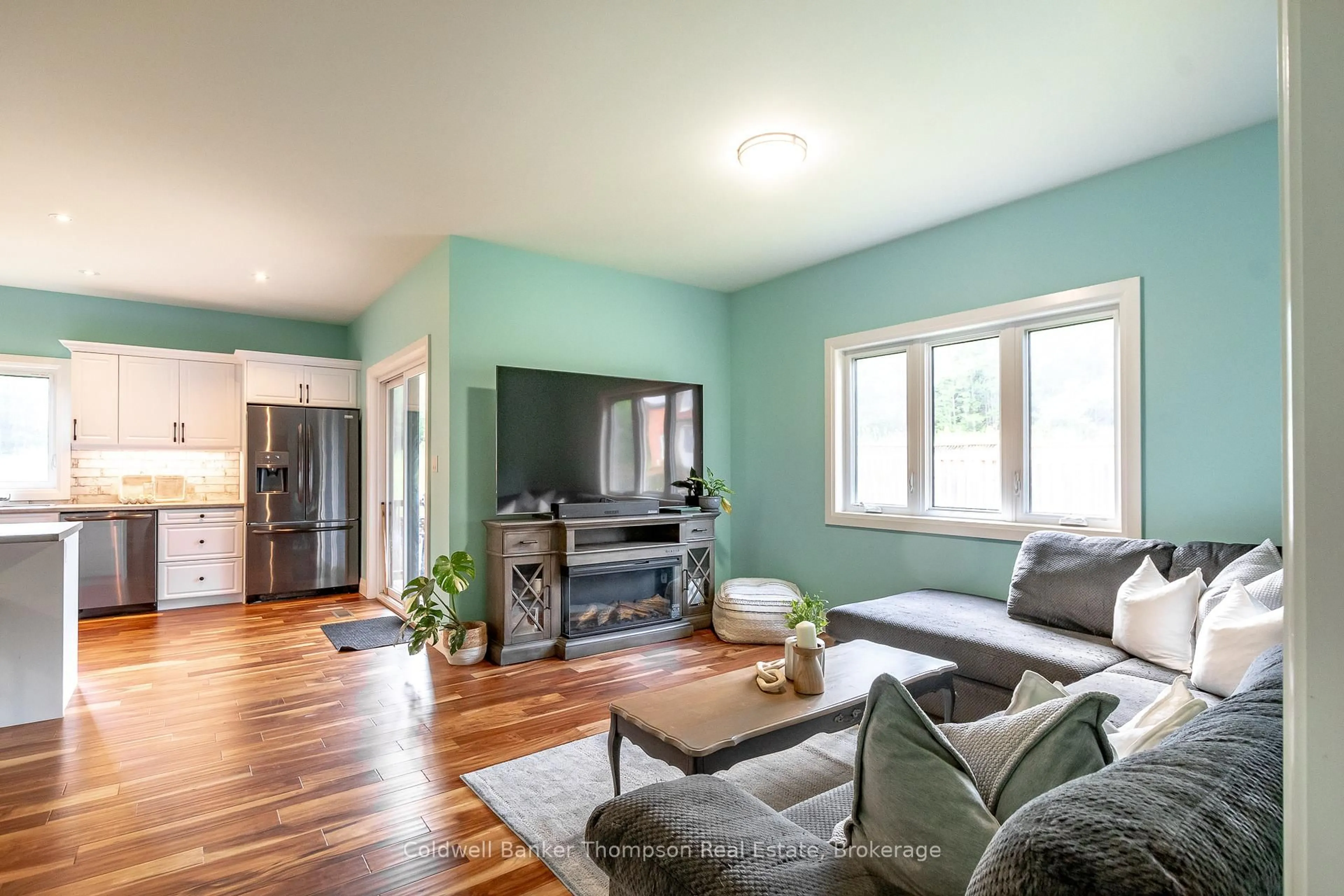 Living room with furniture, wood/laminate floor for 80 Chaffey Township Rd, Huntsville Ontario P1H 1C8