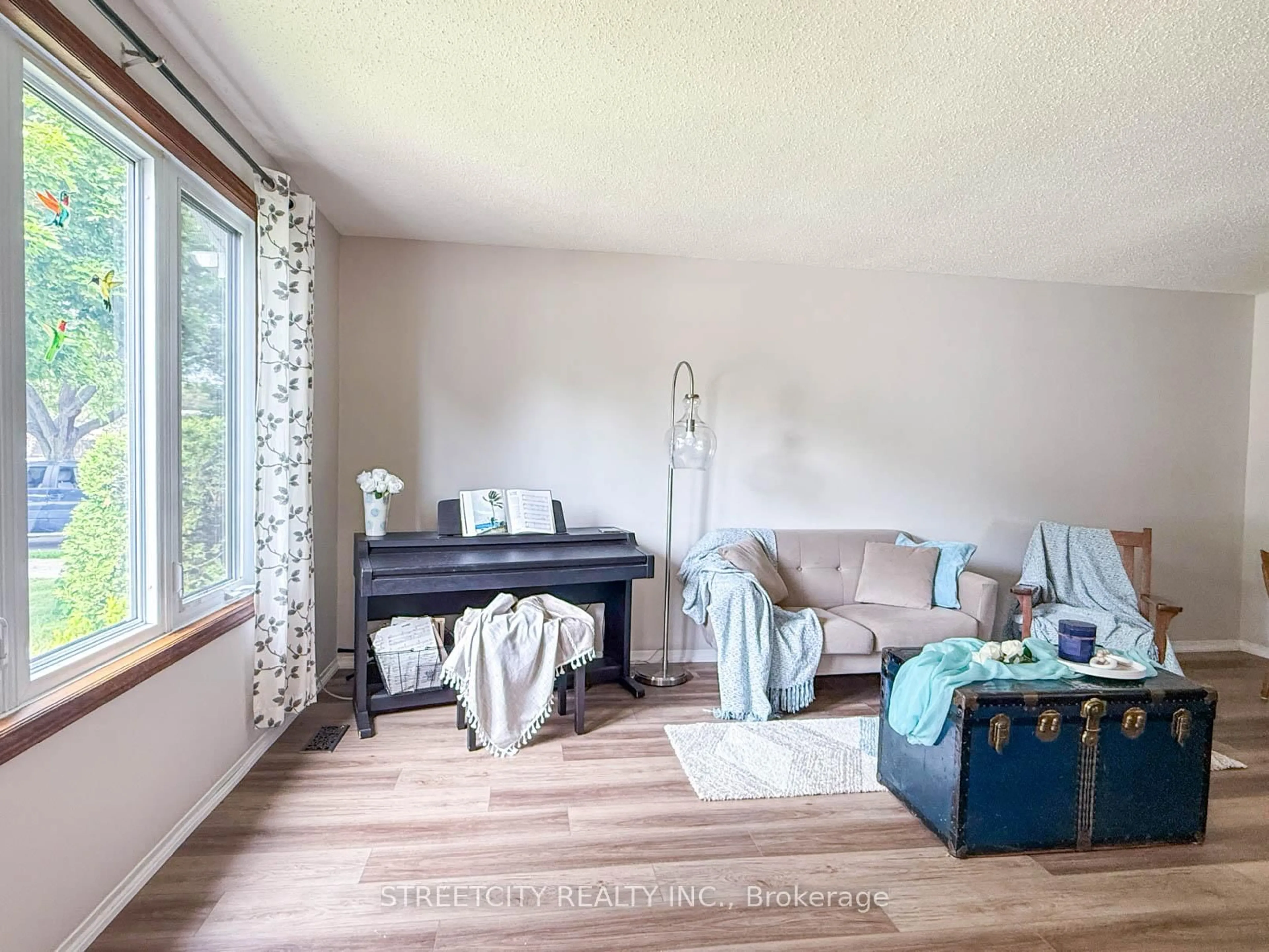 Living room with furniture, wood/laminate floor for 2623 Kaymar Cres, Sarnia Ontario N0N 1C0