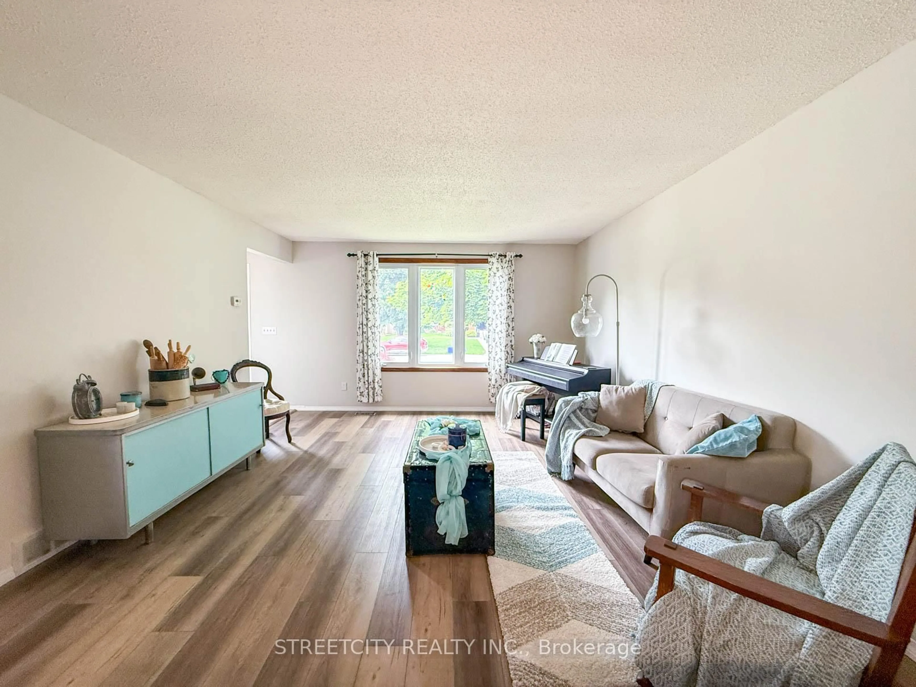 Living room with furniture, wood/laminate floor for 2623 Kaymar Cres, Sarnia Ontario N0N 1C0