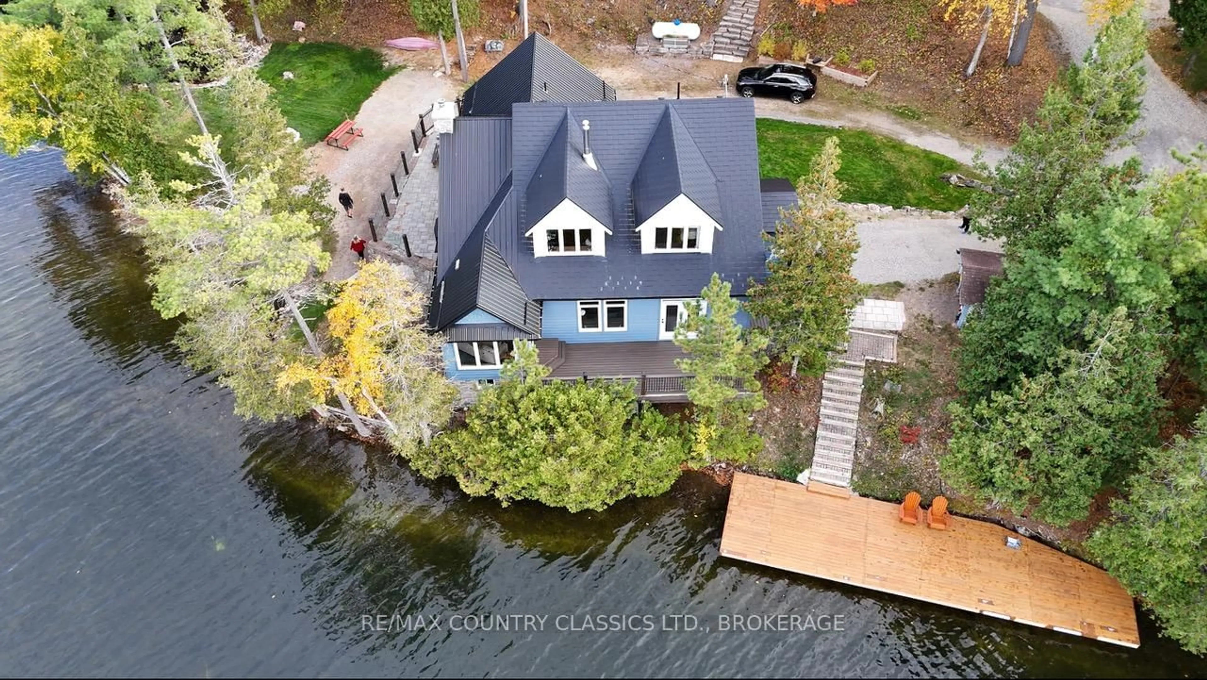 A pic from outside/outdoor area/front of a property/back of a property/a pic from drone, water/lake/river/ocean view for 1021 South Kash Lake Lane, Arden Ontario K0H 1B0