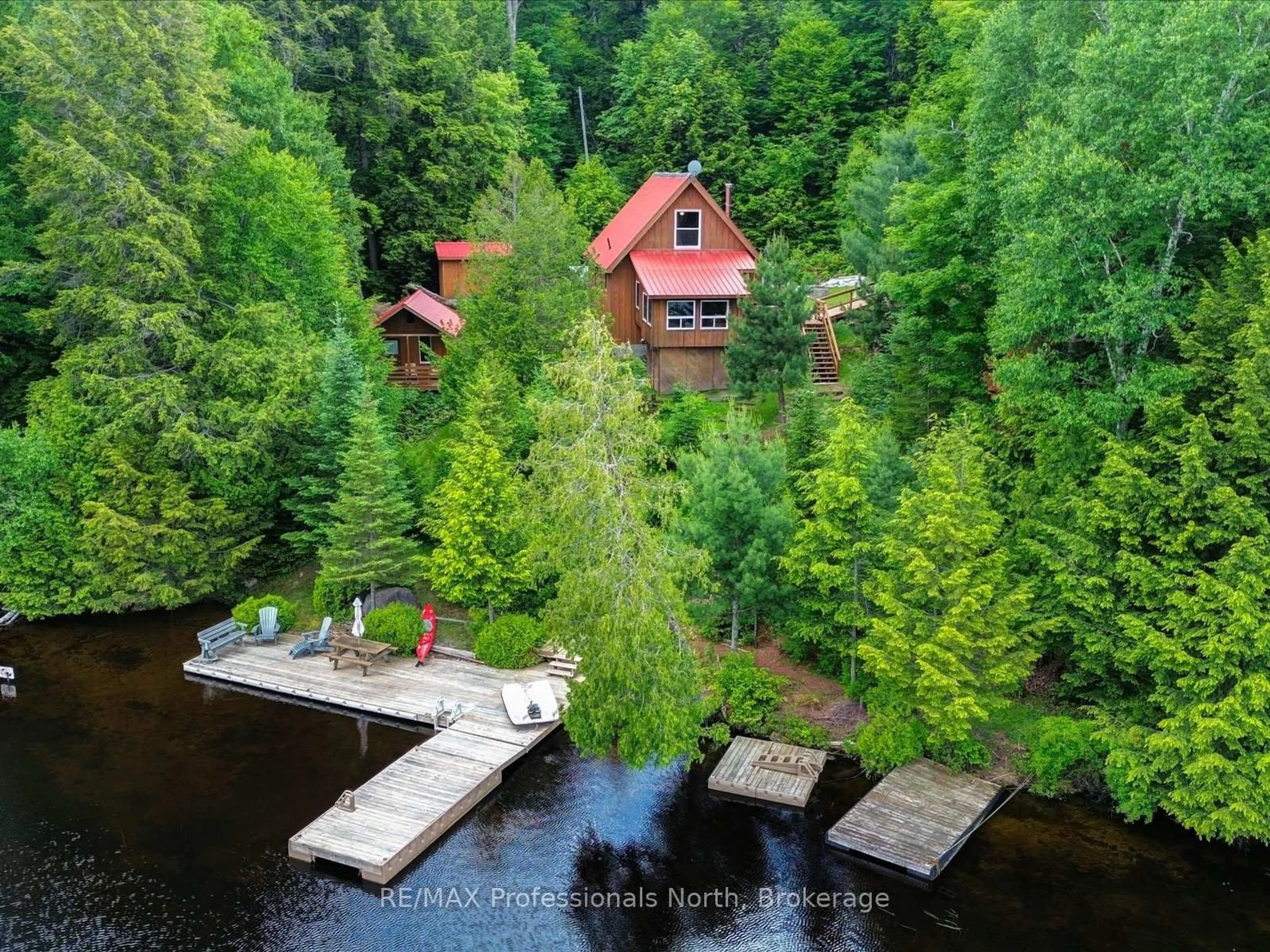 A pic from outside/outdoor area/front of a property/back of a property/a pic from drone, water/lake/river/ocean view for 84 Lakeside Lane, South Algonquin Ontario K0J 2M0