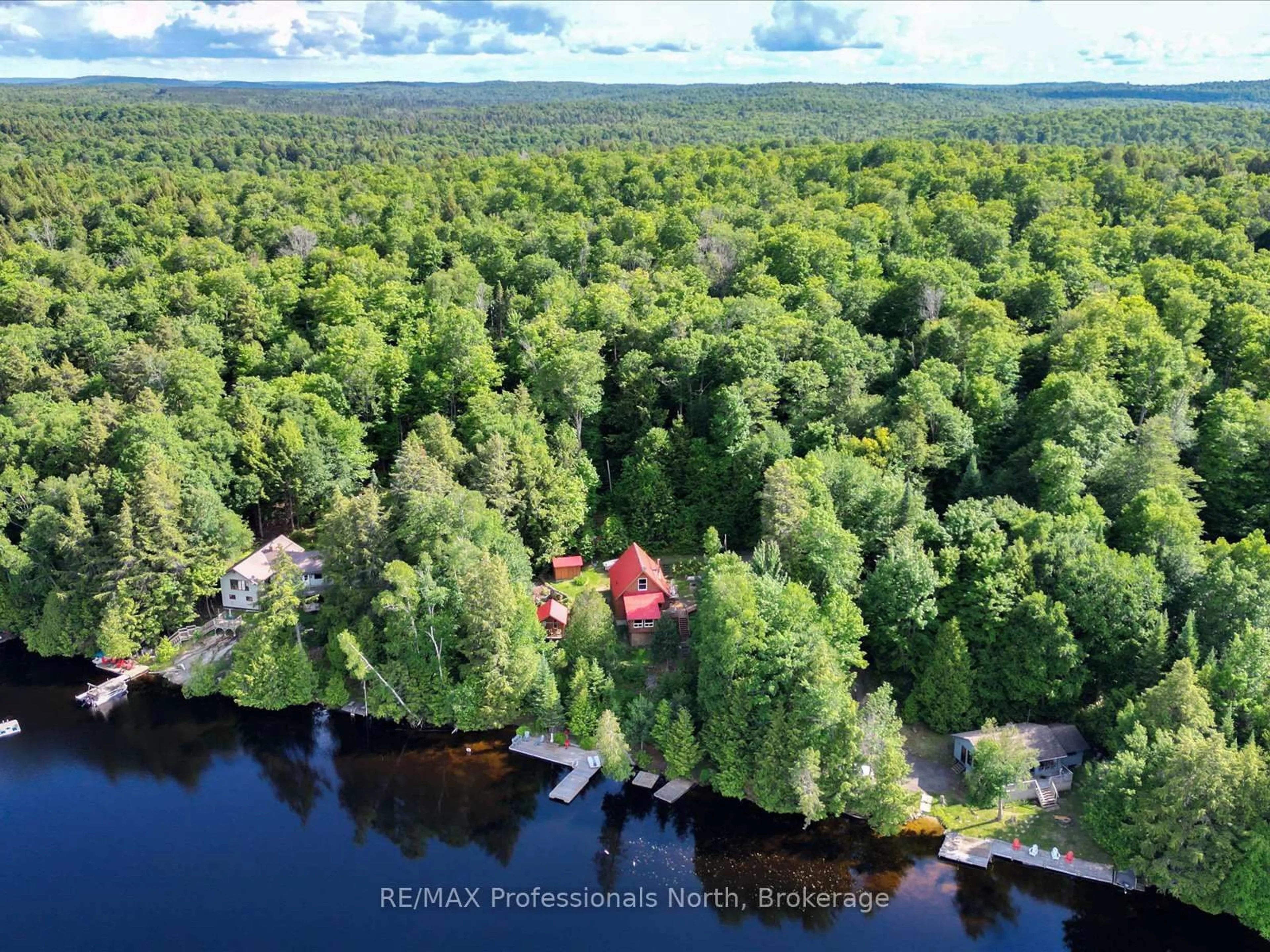 A pic from outside/outdoor area/front of a property/back of a property/a pic from drone, water/lake/river/ocean view for 84 Lakeside Lane, South Algonquin Ontario K0J 2M0