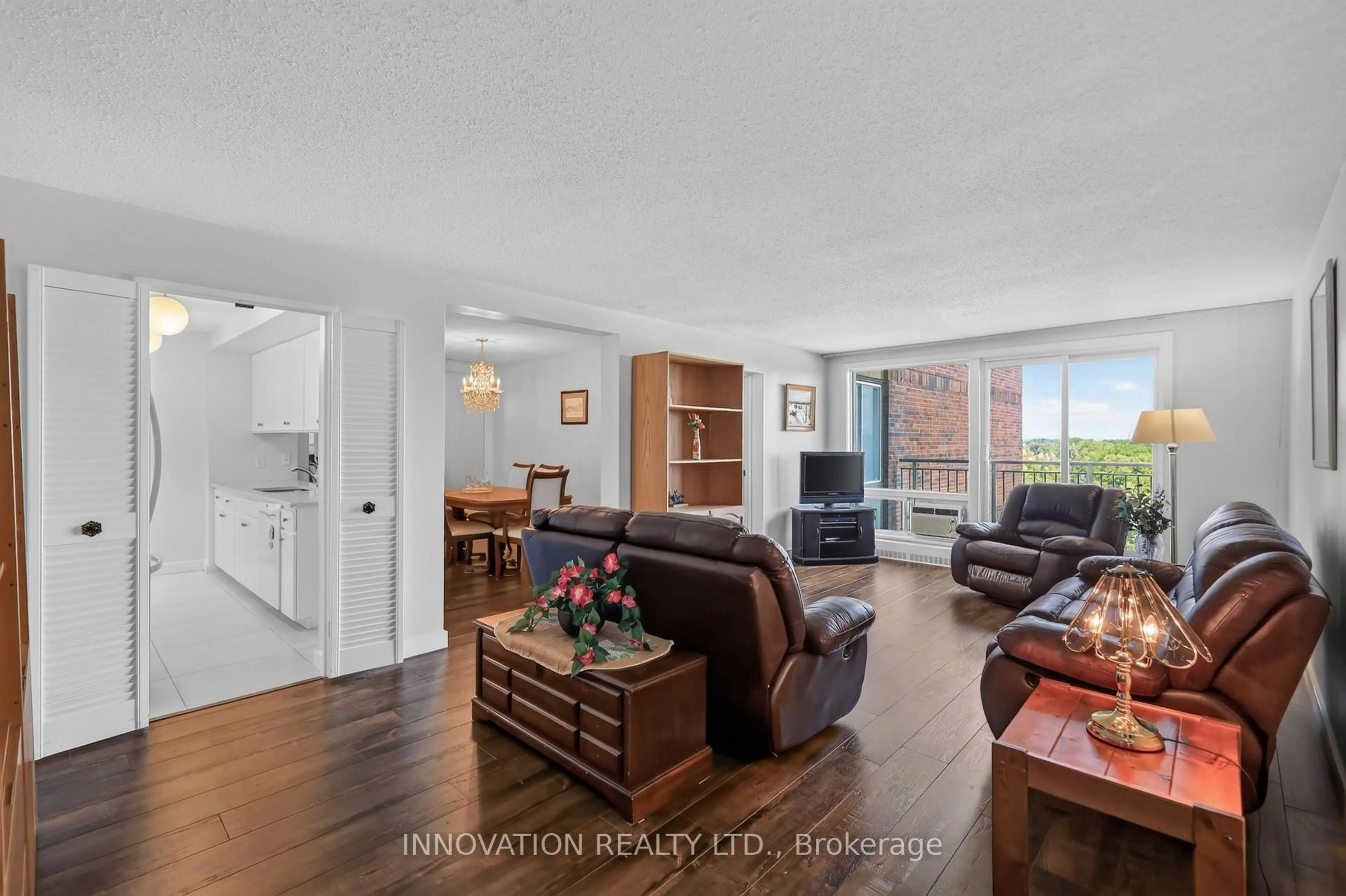 Living room with furniture, wood/laminate floor for 1485 Baseline Rd #705, Ottawa Ontario K2C 3L8