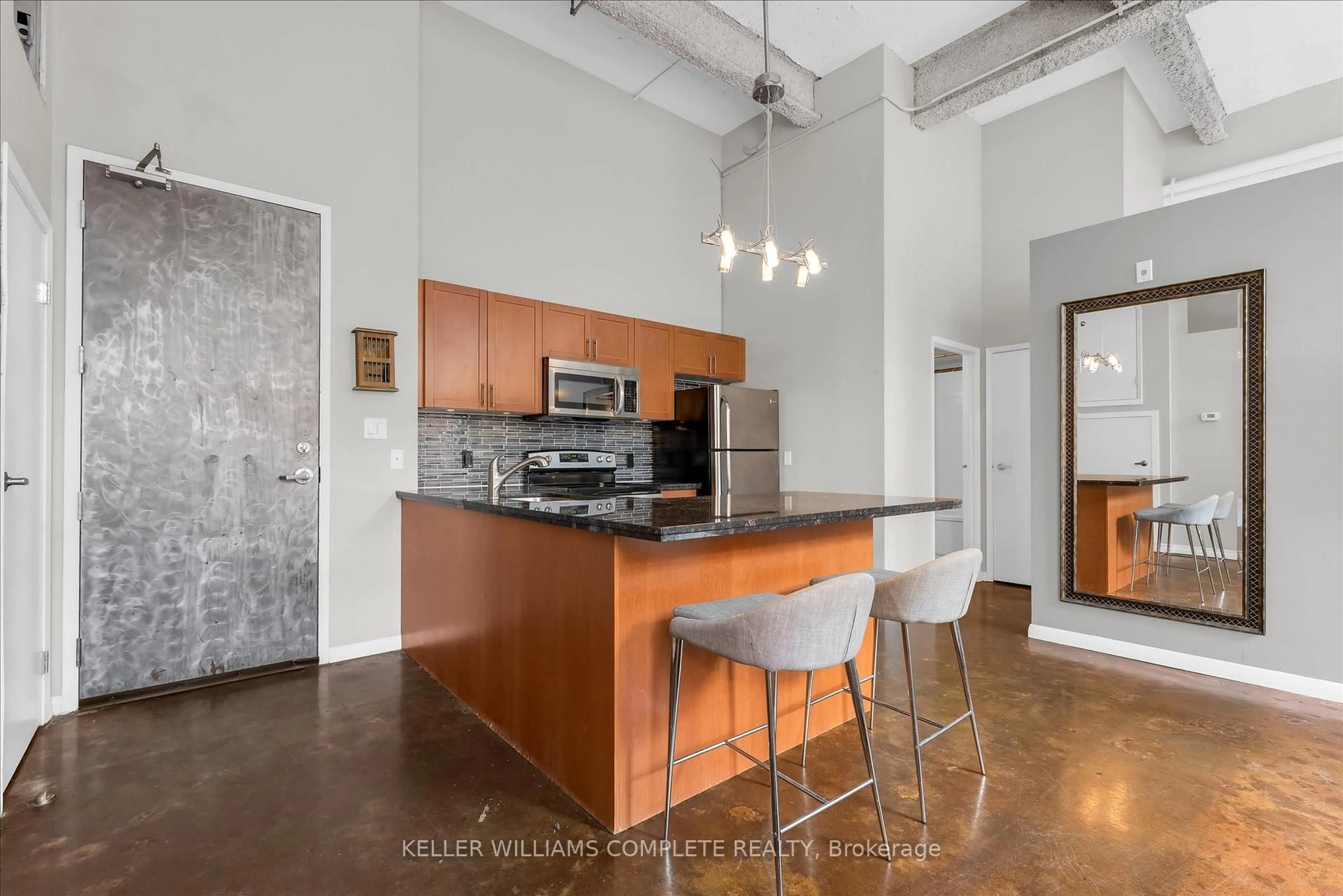 Open concept kitchen, cement floor for 11 Rebecca St #208, Hamilton Ontario L8R 3H7