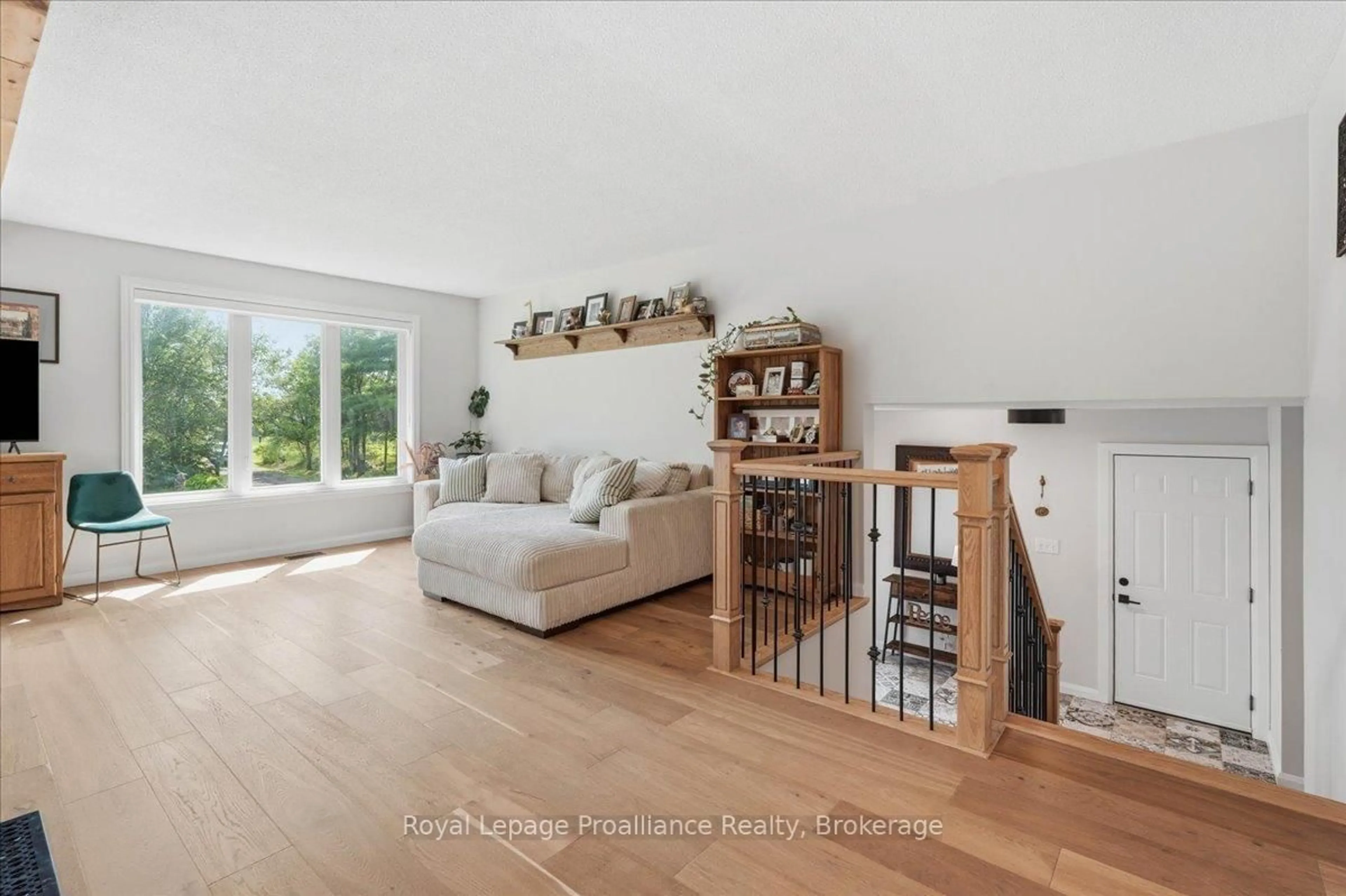 Living room with furniture, wood/laminate floor for 10389 Highway 41, Kaladar Ontario K0H 1Z0