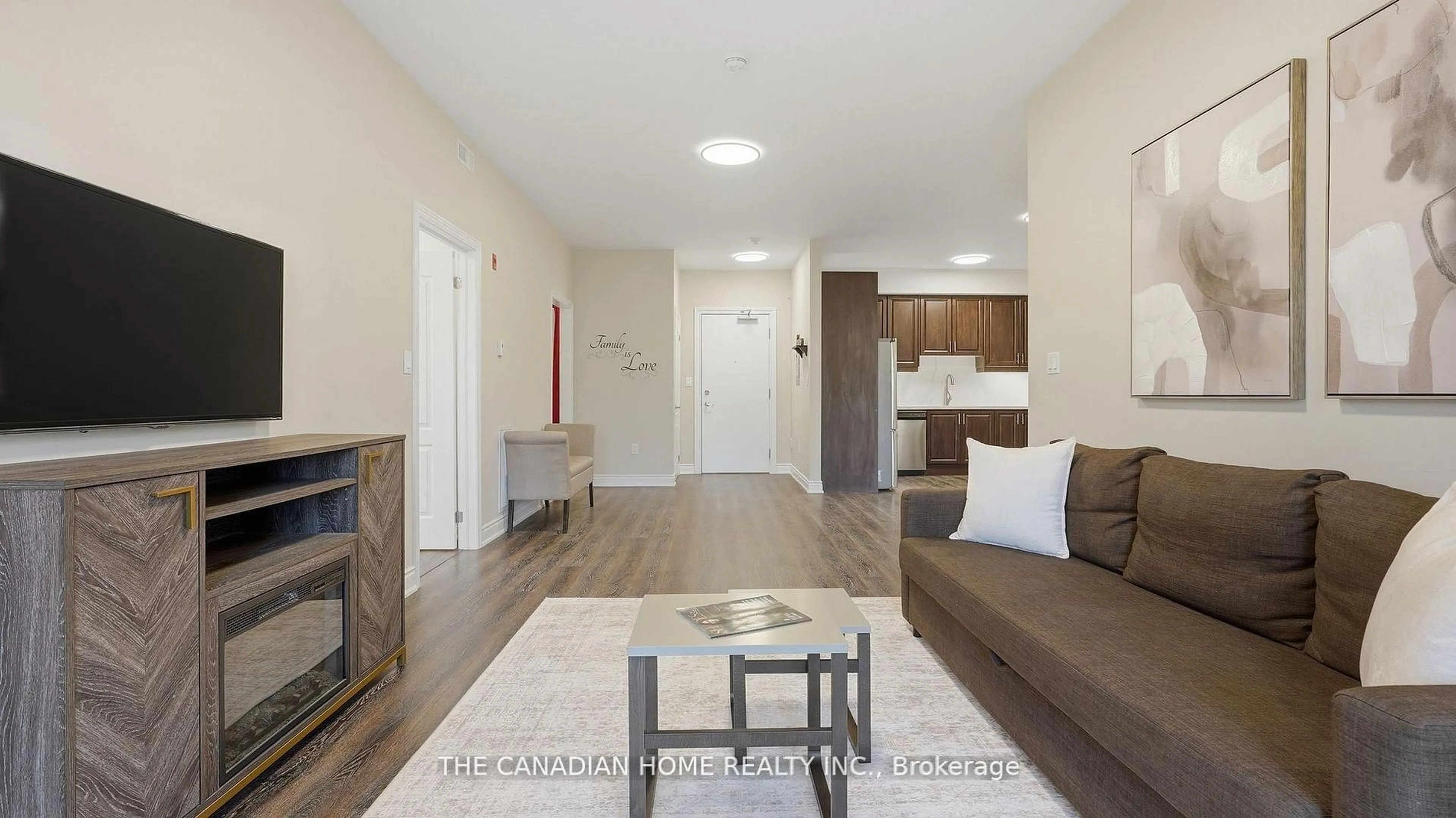 Living room with furniture, wood/laminate floor for 8111 Forest Glen Dr #332, Niagara Falls Ontario L2H 2Y7