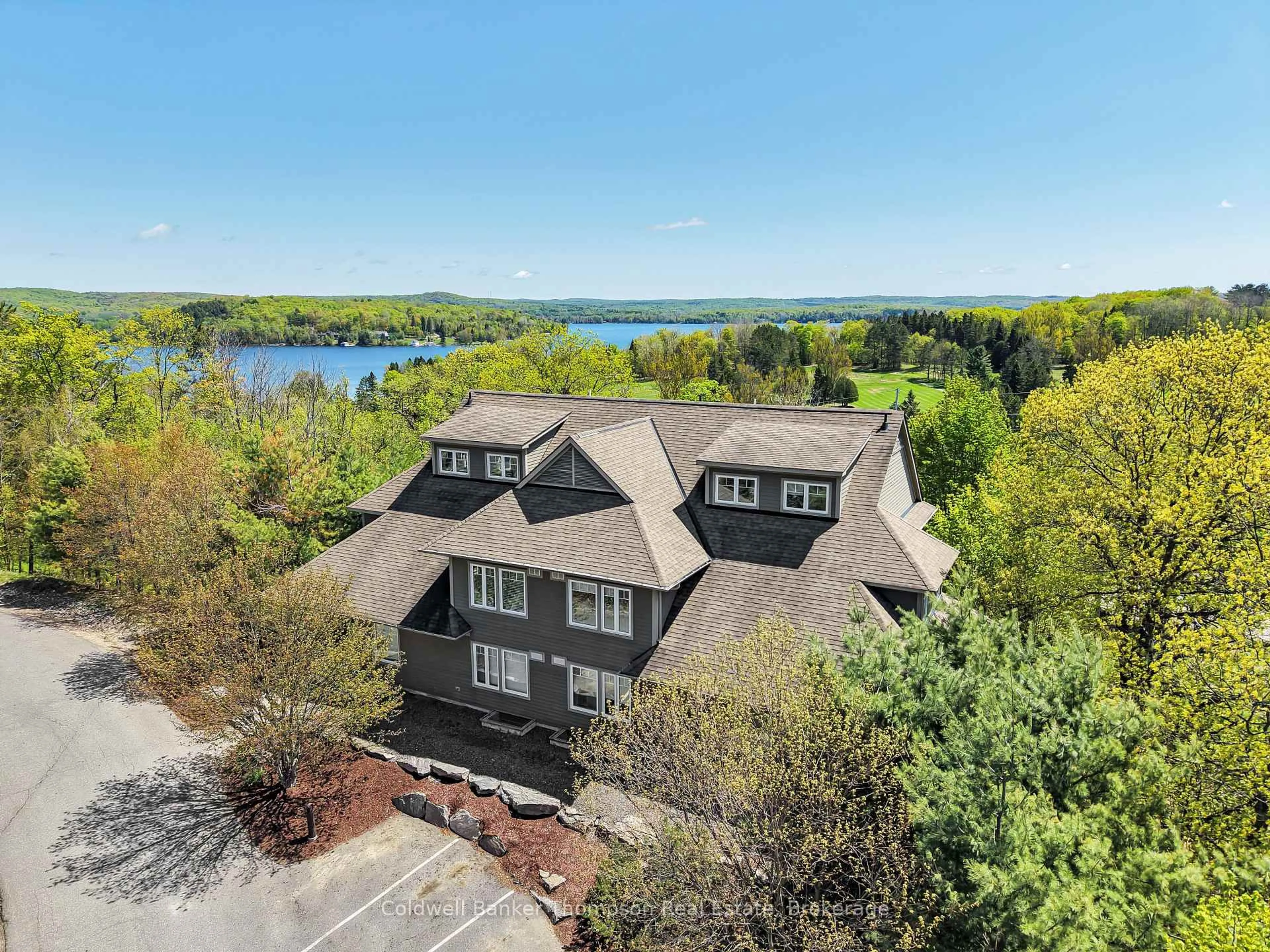 A pic from outside/outdoor area/front of a property/back of a property/a pic from drone, water/lake/river/ocean view for 1 TREE TOPS Lane #302, Huntsville Ontario P1H 1A9