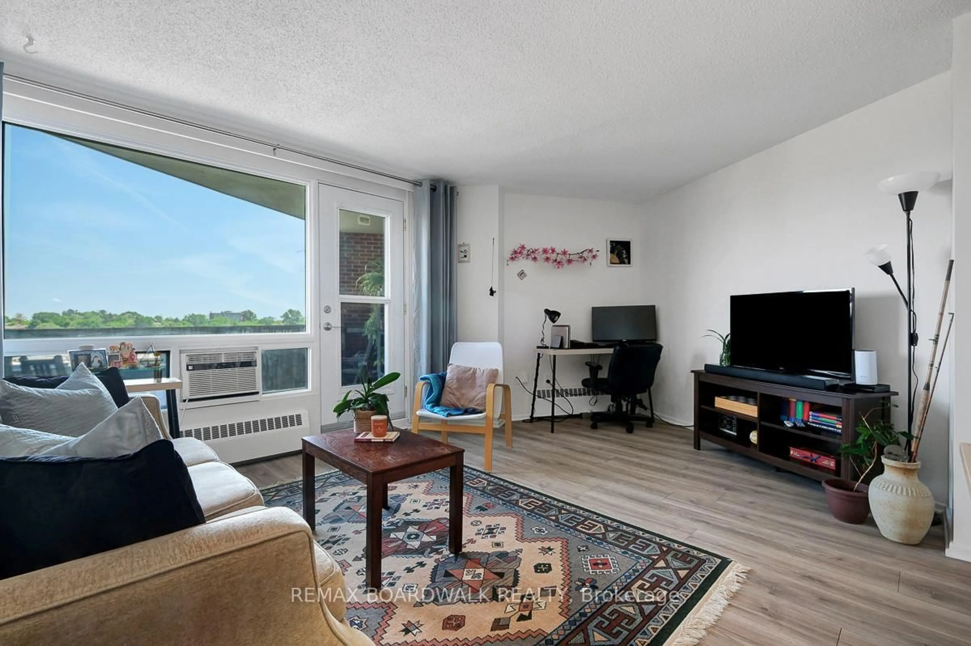 Living room with furniture, wood/laminate floor for 3100 Carling Ave #908, Ottawa Ontario K2B 6J6
