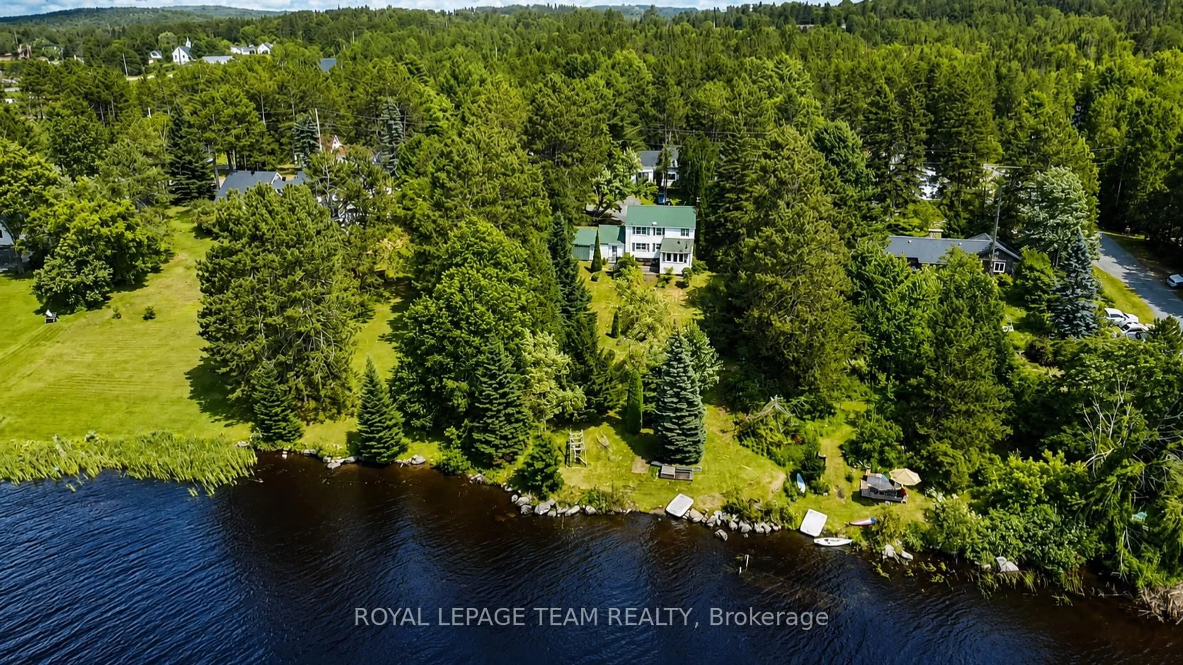 A pic from outside/outdoor area/front of a property/back of a property/a pic from drone, water/lake/river/ocean view for 112 Ottawa St, South Algonquin Ontario K0J 2M0