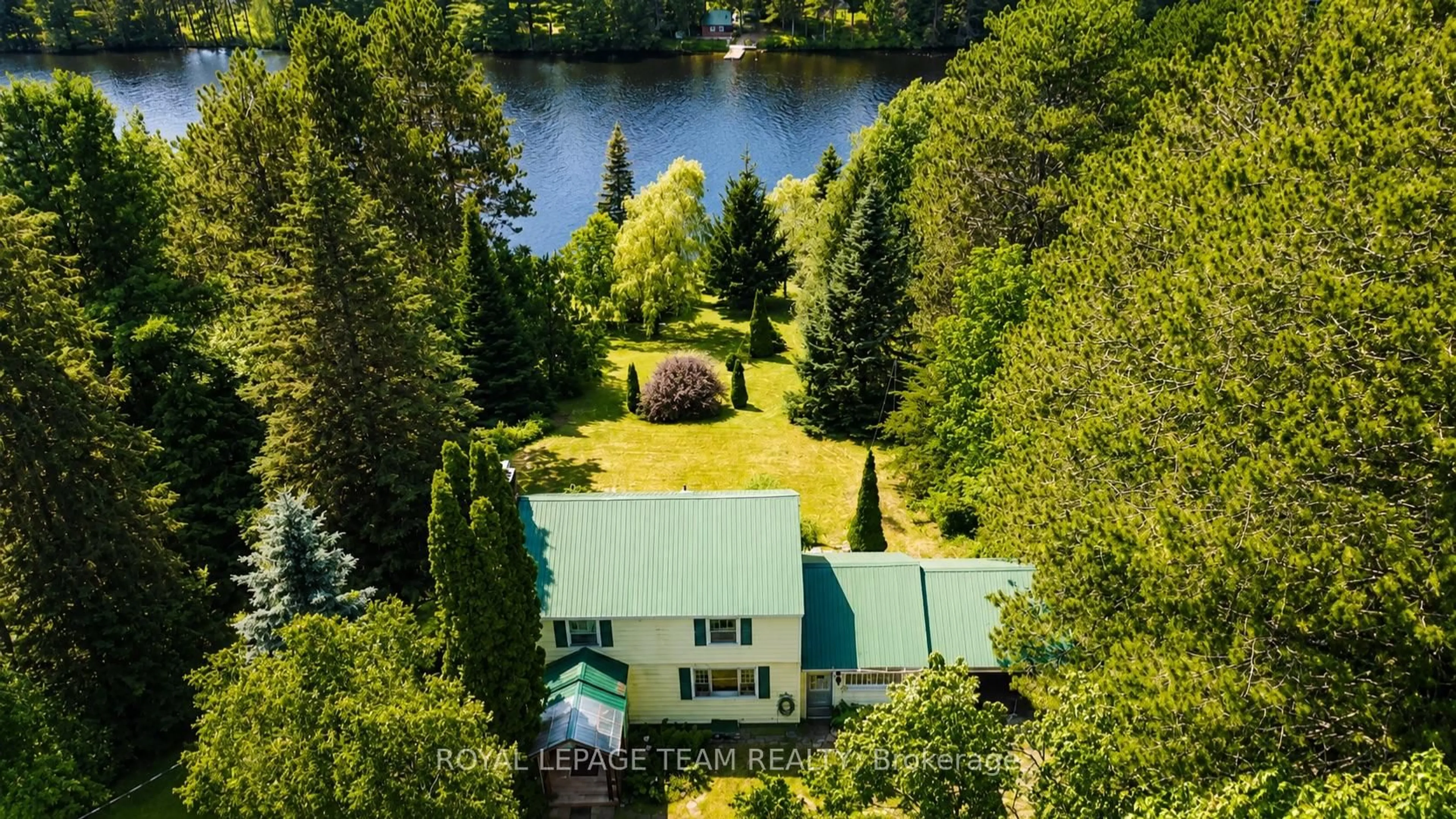 A pic from outside/outdoor area/front of a property/back of a property/a pic from drone, water/lake/river/ocean view for 112 Ottawa St, South Algonquin Ontario K0J 2M0